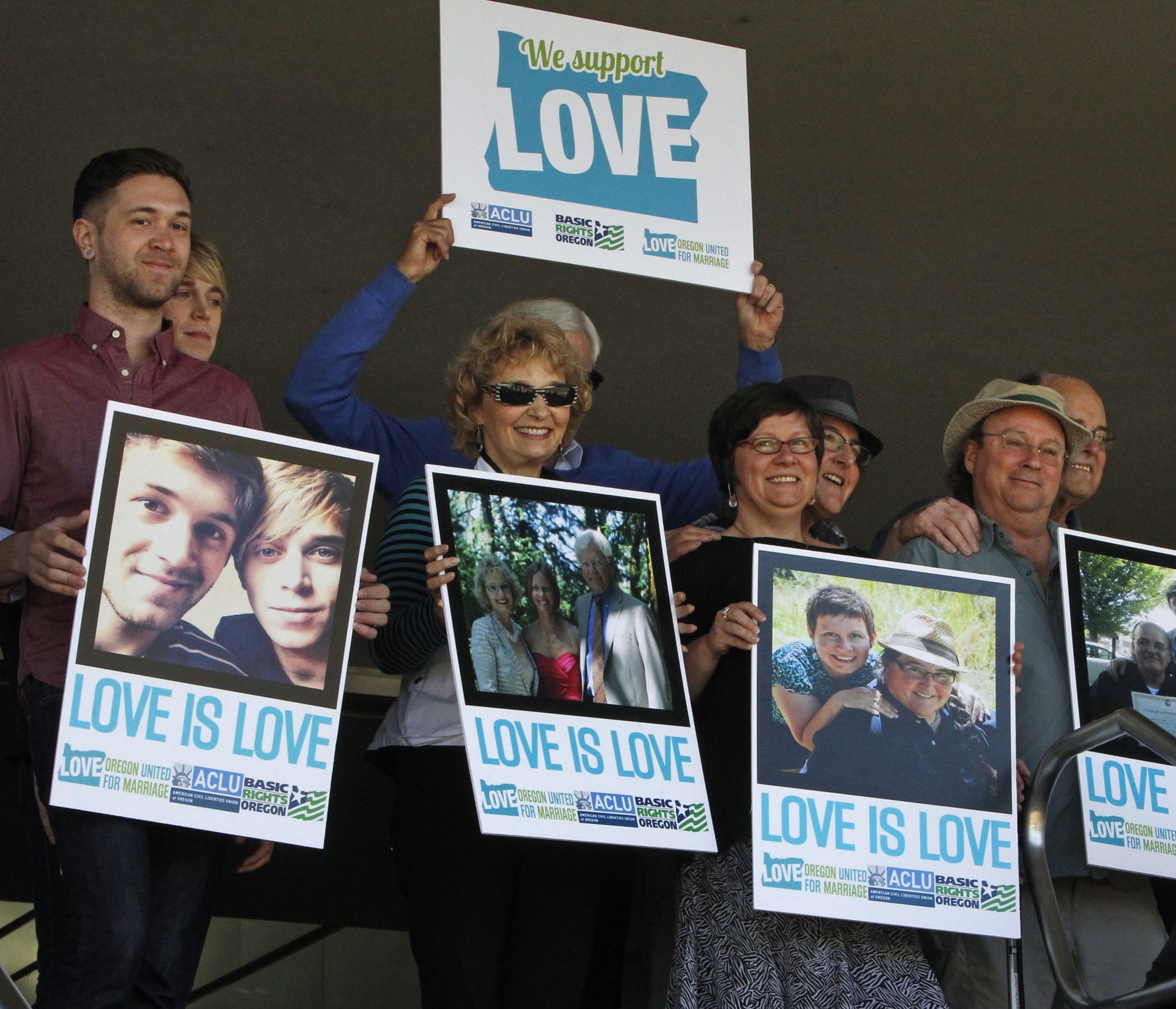 Supporters of same-sex marriage hold photos of themselves and their family members or partners on the steps of the Wayne L Morse U.S.