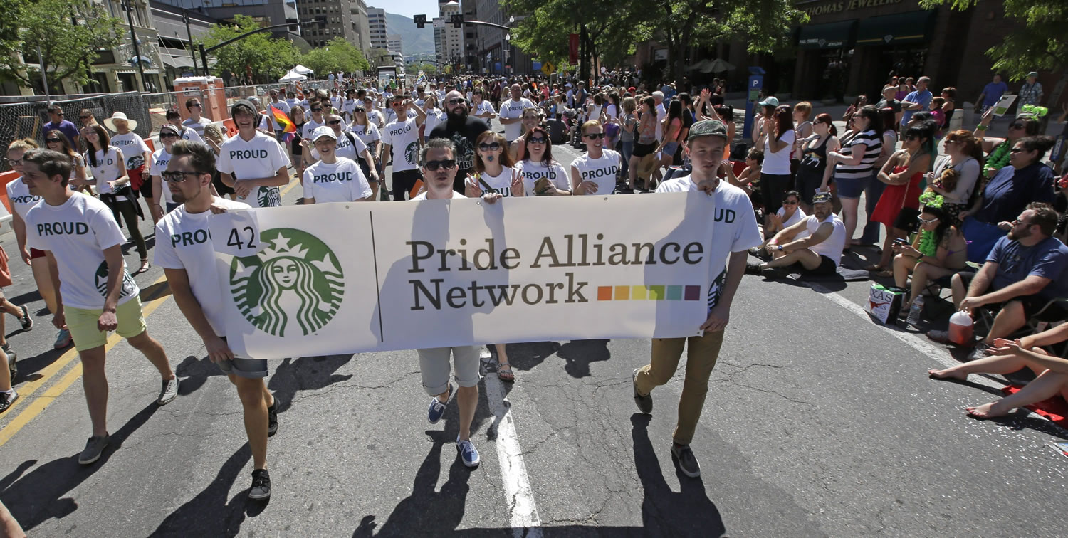 Workers carry a Starbucks banner during the June 8 gay pride parade in Salt Lake City.