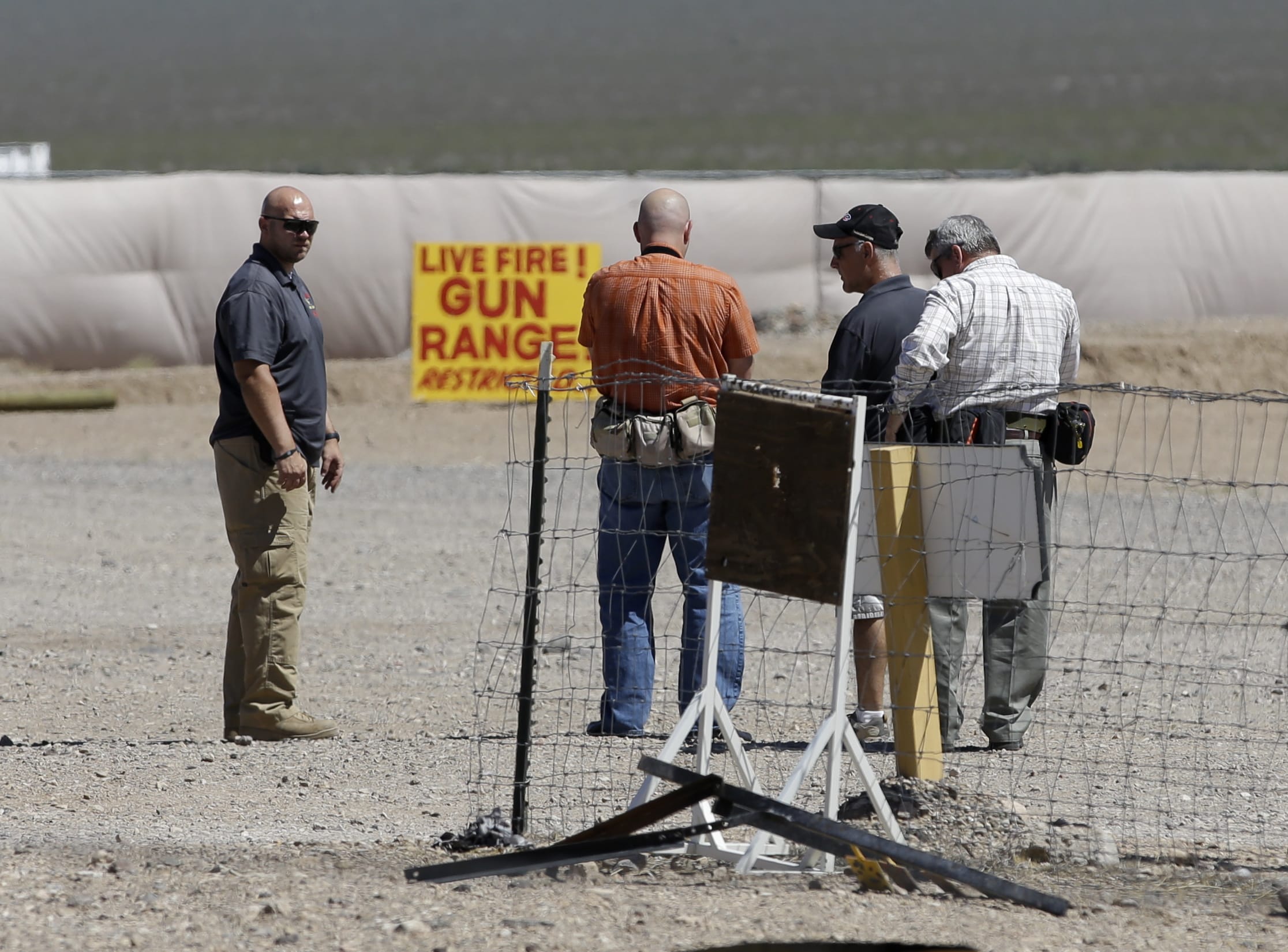 People are seen at the Last Stop outdoor shooting range Wednesday, Aug. 27, in White Hills, Ariz. Gun range instructor Charles Vacca was accidentally killed Monday, Aug. 25, at the range by a 9-year-old with an Uzi submachine gun.