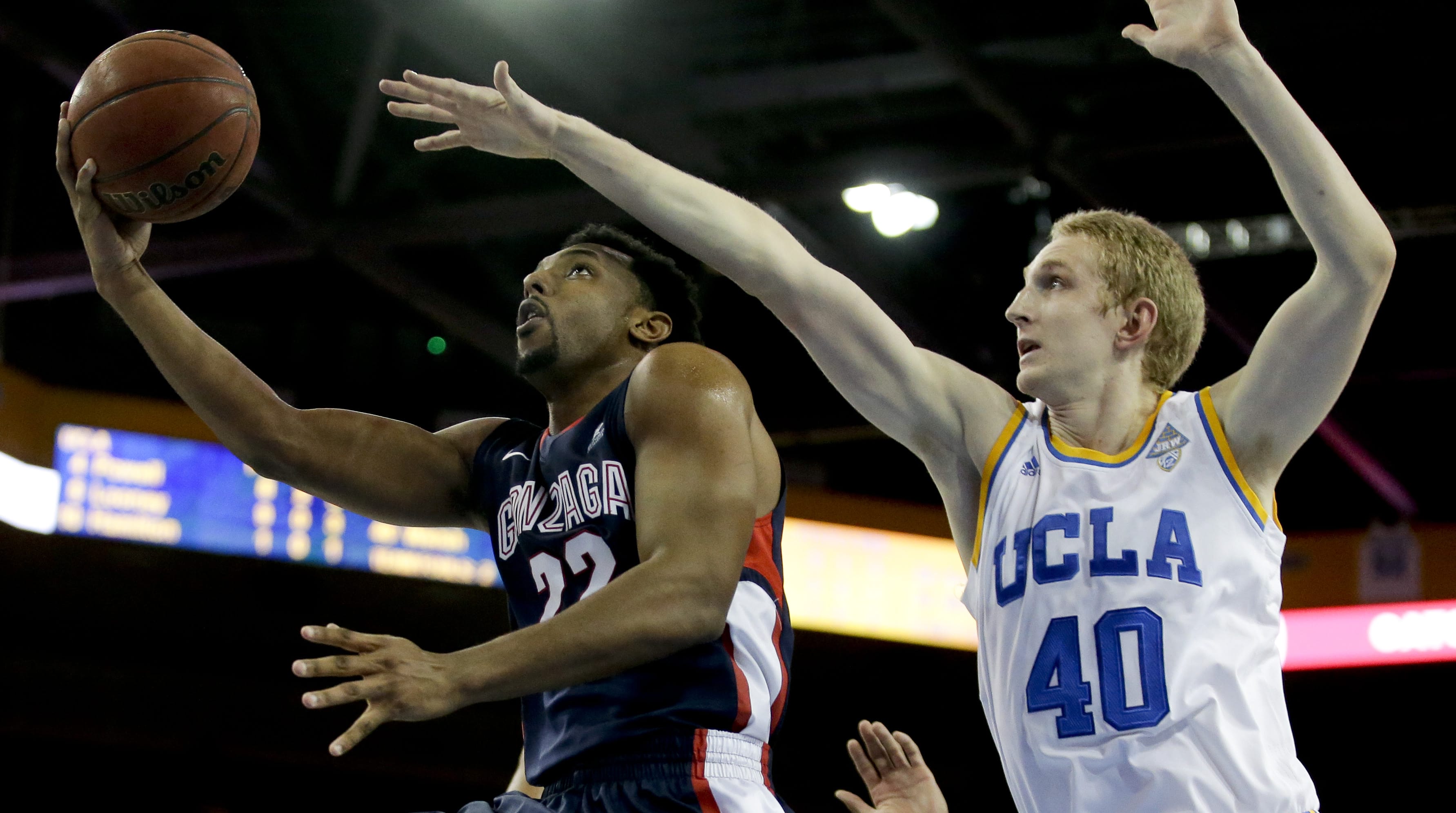 Gonzaga guard Byron Wesley, left, shots around UCLA center Thomas Welsh during the first half in Los Angeles, Saturday, Dec. 13, 2014.