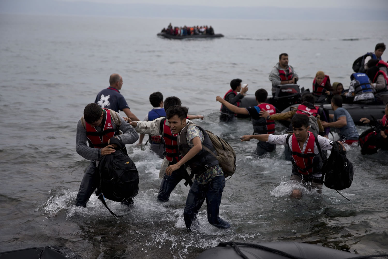 Migrants arrive on the shores of the Greek island of Lesbos Tuesday after crossing the Aegean Sea from Turkey on an inflatable dinghy. More than 260,000 asylum-seekers have arrived in Greece so far this year, most reaching the country's eastern islands on flimsy rafts or boats from the nearby Turkish coast.