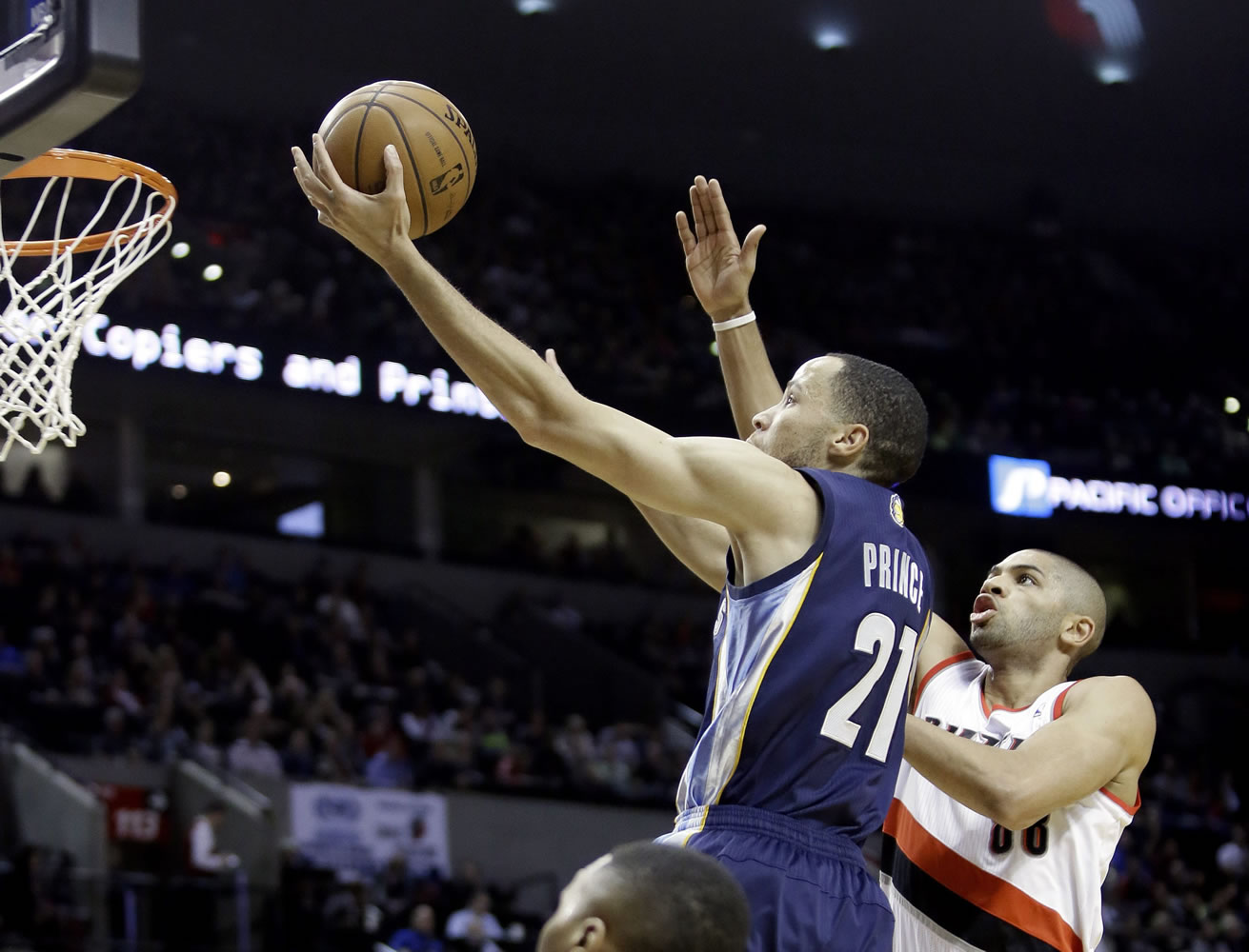 Memphis Grizzlies forward Tayshaun Prince, left, drives to the hoop past Portland Trail Blazers forward Nicolas Batum during the first half of an NBA basketball game in Portland on Tuesday.