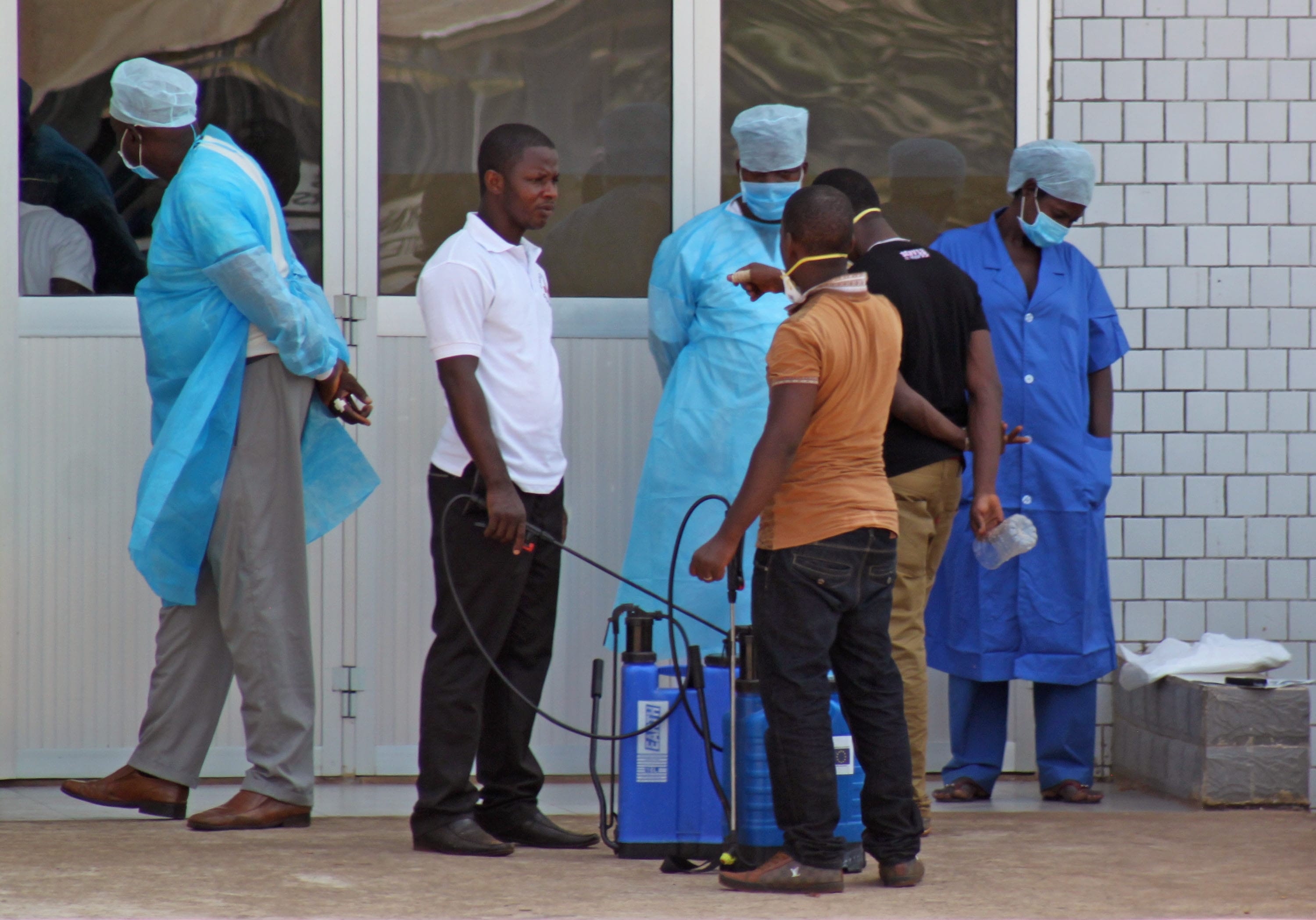 Medical personnel at the emergency entrance of a hospital receive suspected Ebola virus patients in Conakry, Guinea, in late March.