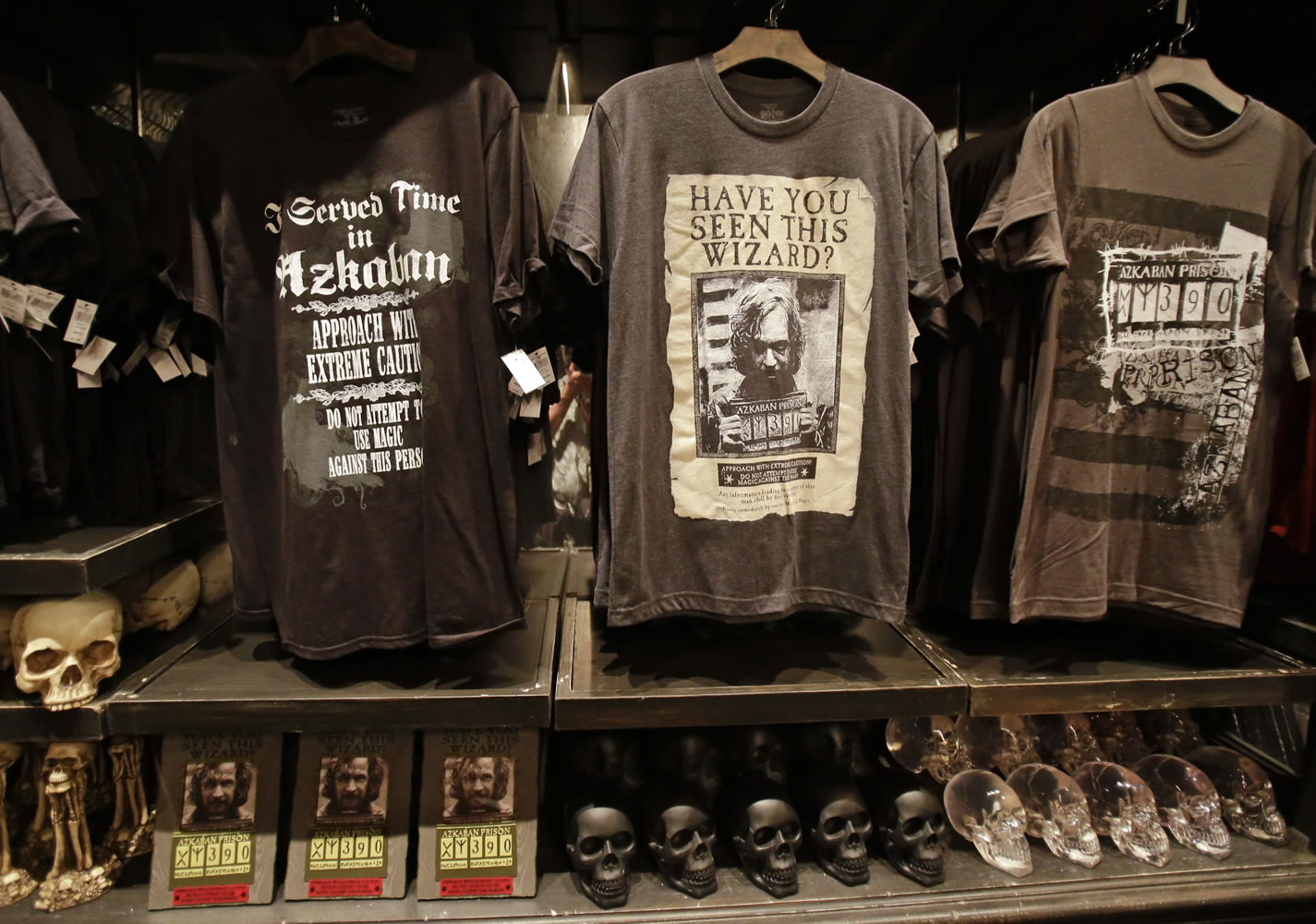 T-shirts and ceramic skulls are displayed at Borgin and Burkes in Knockturn Alley during a preview Thursday of Diagon Alley at the Wizarding World of Harry Potter at Universal Orlando in Orlando, Fla.