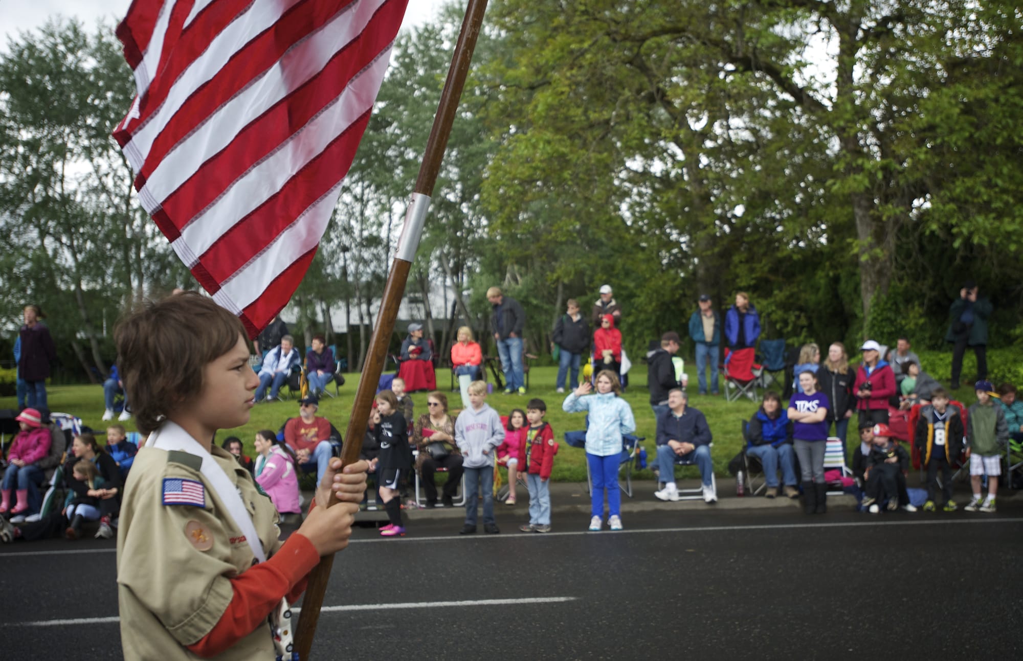Zachariah Taylor of Vancouver holds the American flag while representing Cub Scout Pack 306 in the 2013 Parade of Bands in Hazel Dell.