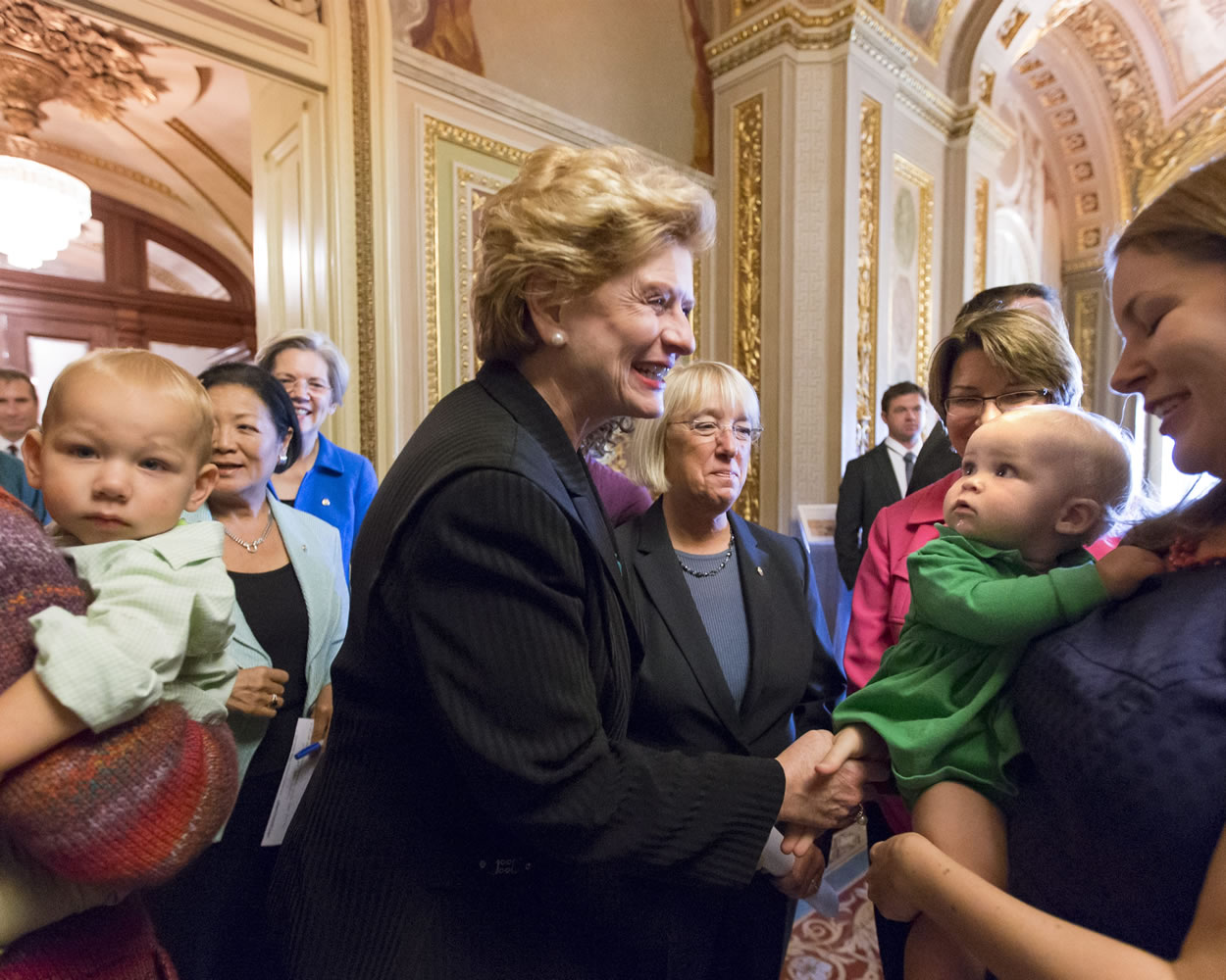 Sen. Debbie Stabenow, D-Mich., center, and Sen. Patty Murray, D-Wash., center right, and other Democratic lawmakers joined new mothers and their babies Sept. 25, 2013 at the Capitol to criticize Republican efforts to kill the Affordable Care Act in Washington.