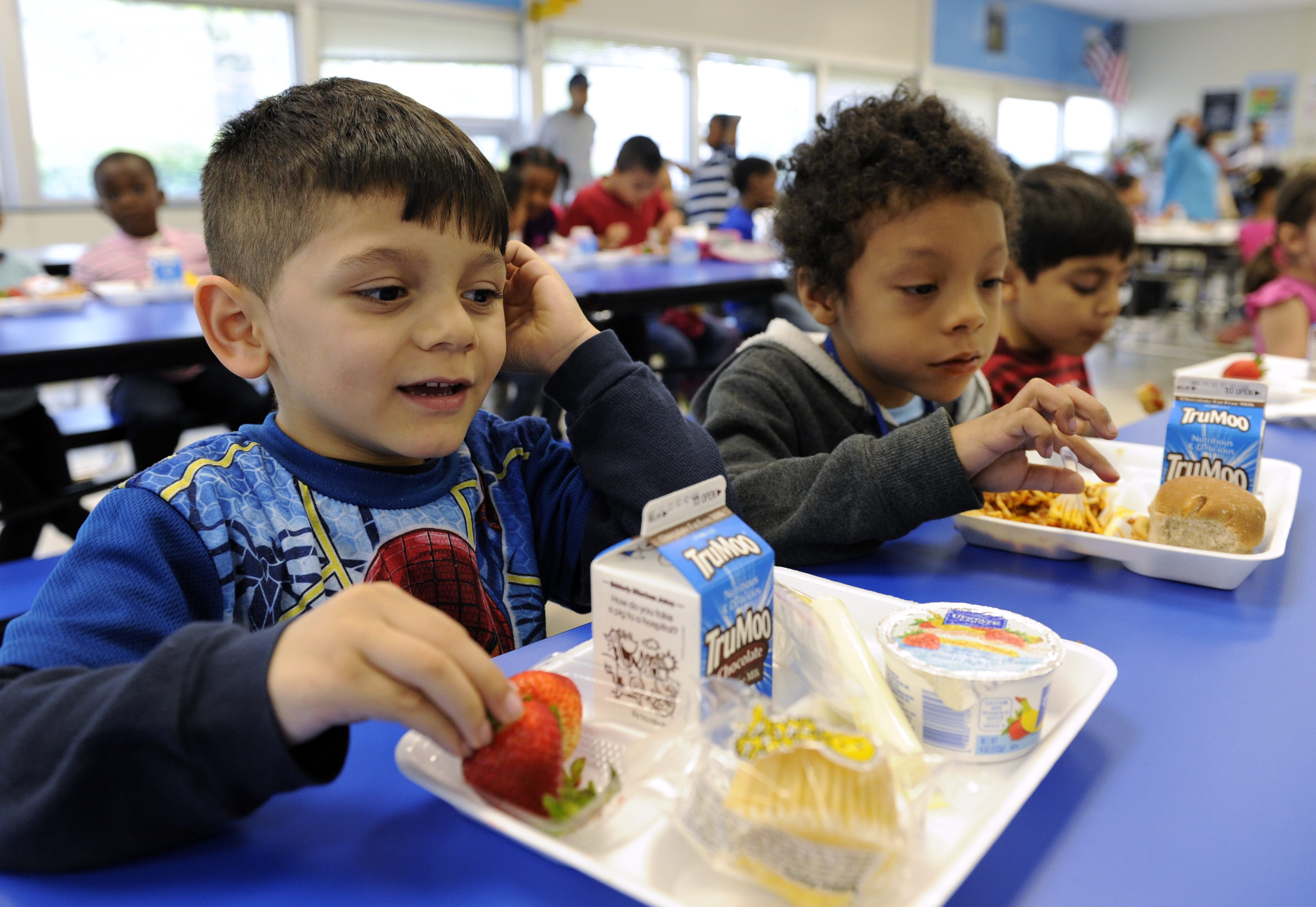 In this Tuesday, April 29, 2014 photo, Biden Arias-Romers, 5, left, and Nathaniel Cossio-Boatwright, 6, eat lunch at the Patrick Henry Elementary School in Alexandria, Va. Starting next school year, pasta and other grain products in schools will have to be whole-grain rich, or more than half whole grain. The requirement is part of a government effort to make school lunches and breakfasts healthier.