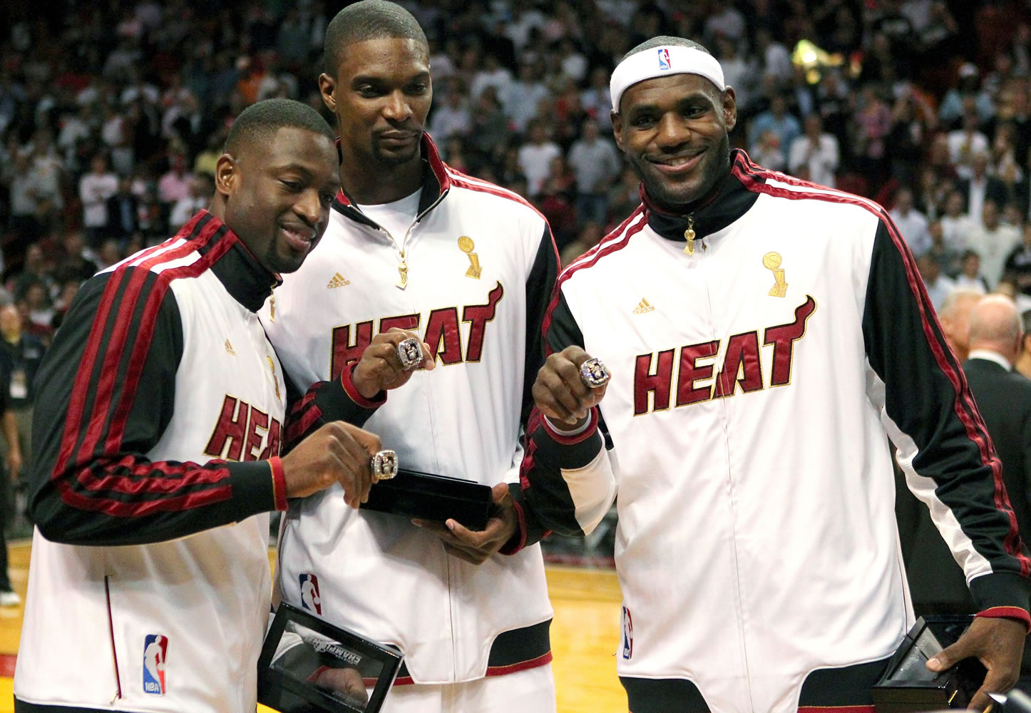 Miami Heat's Dwyane Wade, left, Chris Bosh, center, and LeBron James pose with their championship rings in 2012.