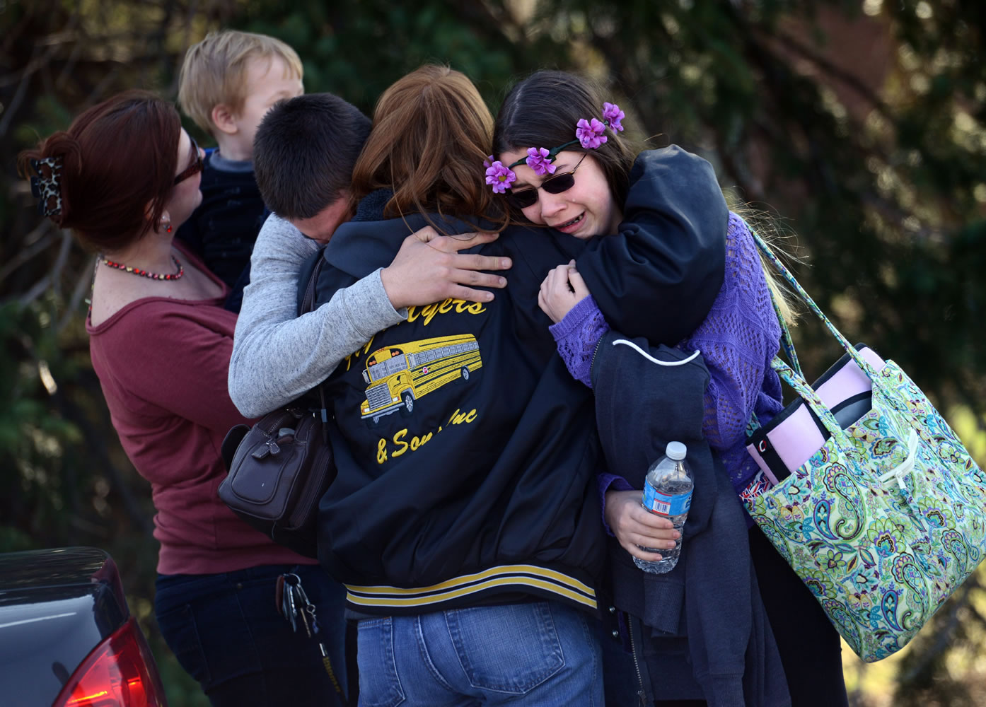 Parents and students embrace along School Road near Franklin Regional High School after more than a dozen students were stabbed by a knife wielding suspect at the school on Wednesday in Murrysville, Pa., near Pittsburgh.