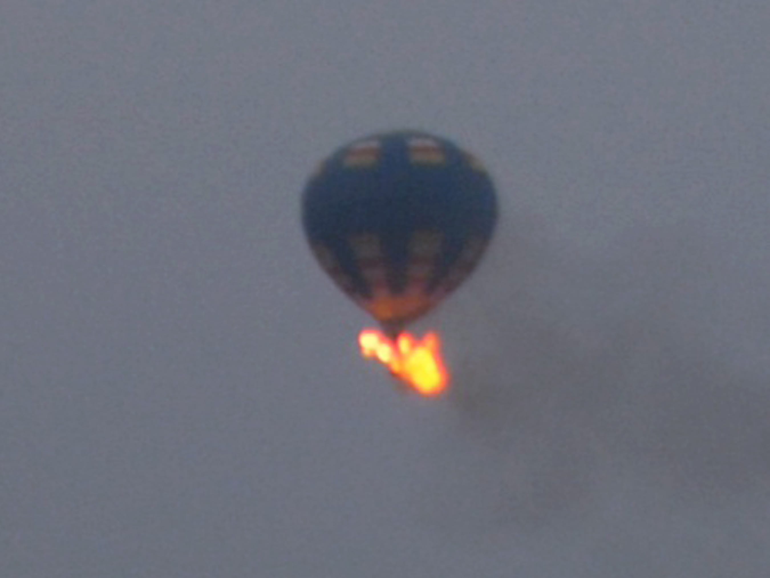 This photo provided by Nancy Johnson shows what authorities say is a hot-air balloon that wass believed to have caught fire and crashed in Virginia on Friday. Virginia State Police received calls of the crash shortly before 8 p.m., police spokeswoman Corinne Geller told a news conference.