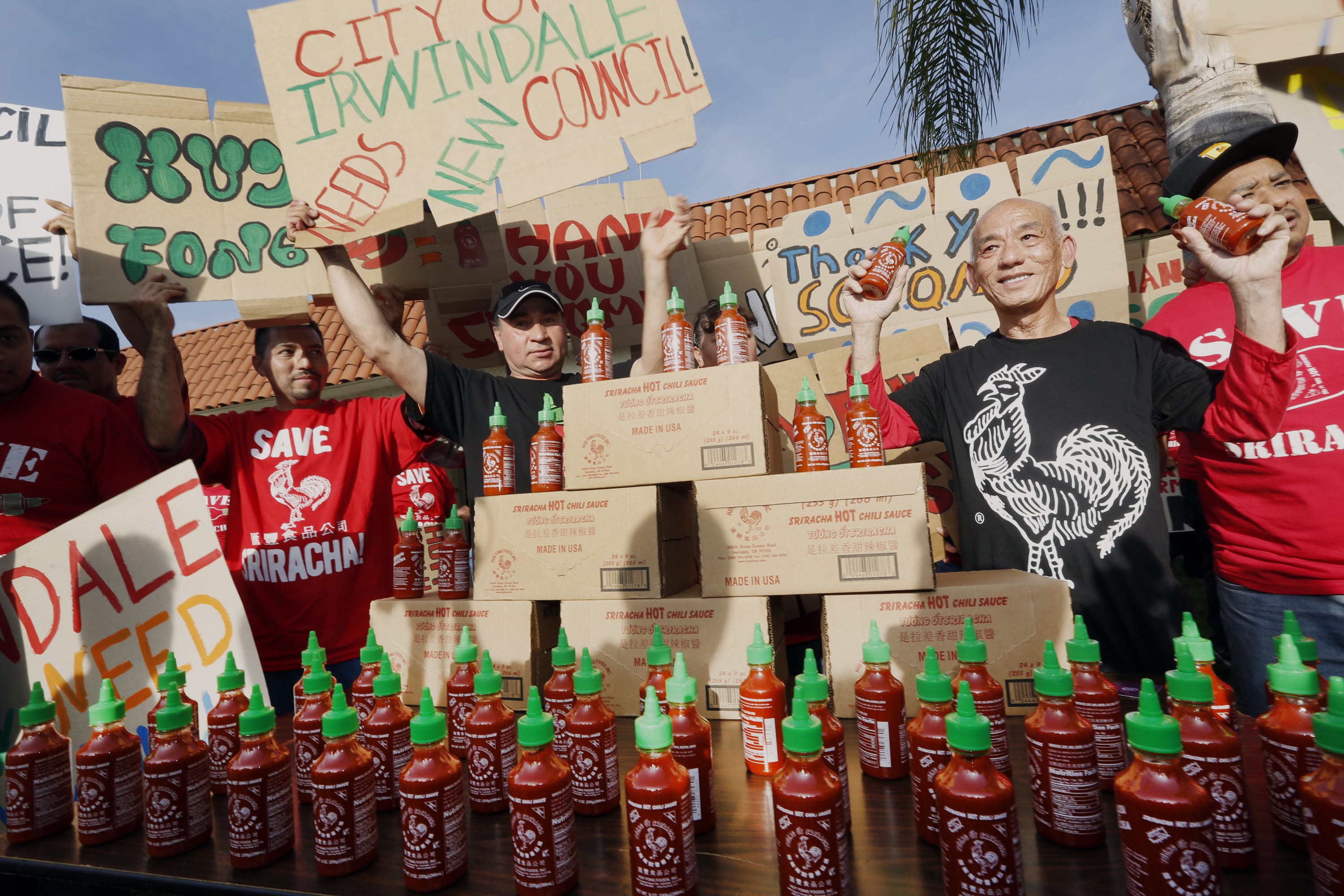 Sriracha hot sauce founder David Tran, second from right, with his workers and supporters protest ahead of the city council meeting in Irwindale, Calif., on April 23.