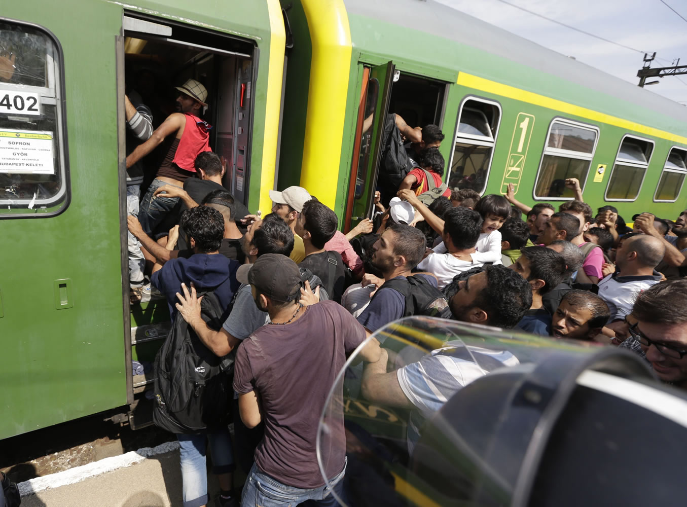 Migrants get back on a train in Bicske, Hungary, Thursday, Sept. 3, 2015. Over 150,000 migrants have reached Hungary this year, most coming through the southern border with Serbia. Many apply for asylum but quickly try to leave for richer EU countries.