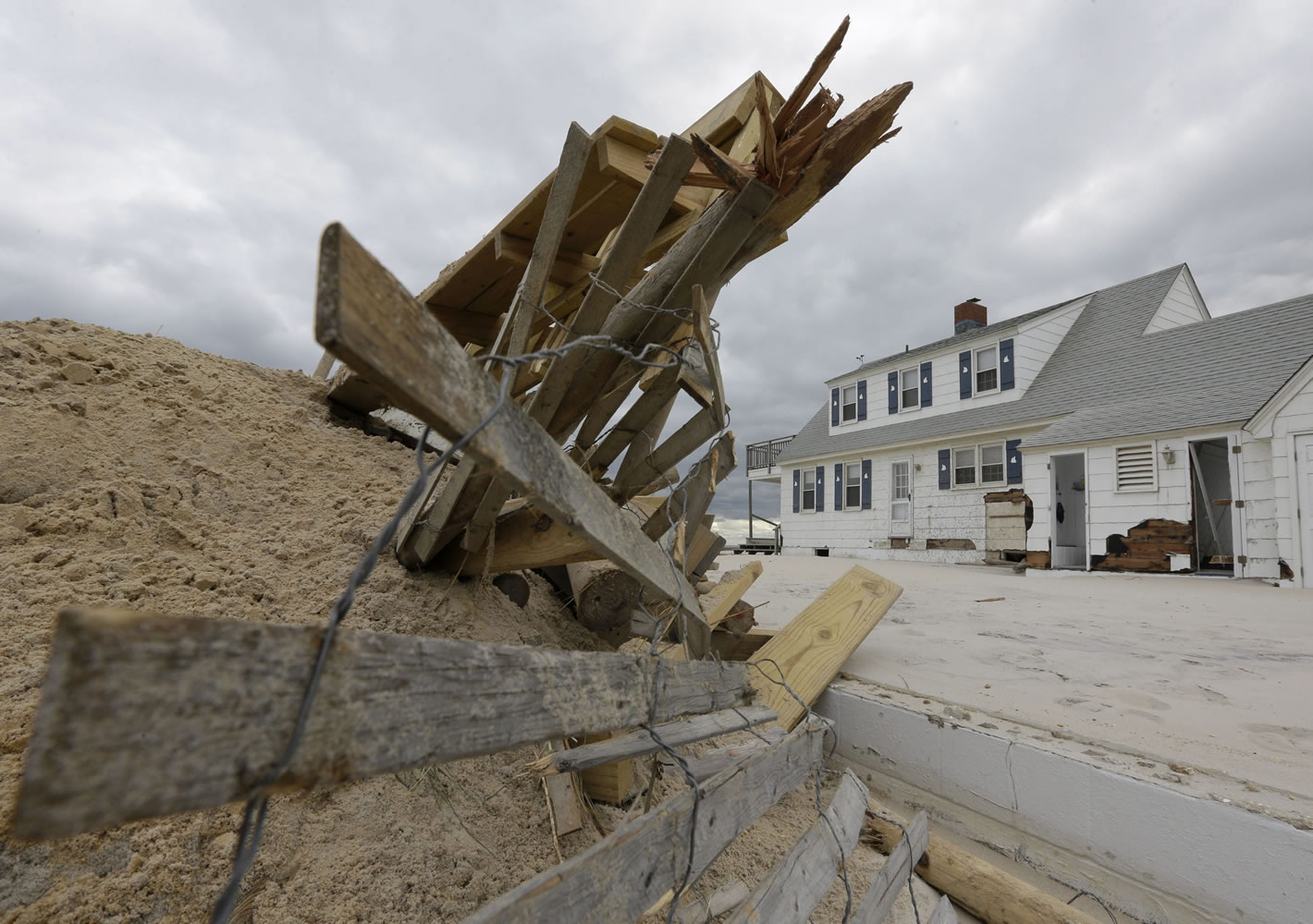 Associated Press files
This Nov. 1, 2012 file photo shows a pile of sand and debris following superstorm Sandy in Brant Beach, N.J. A new psychology study shows that people are wrongly less prone to flee from hurricanes with feminine names.