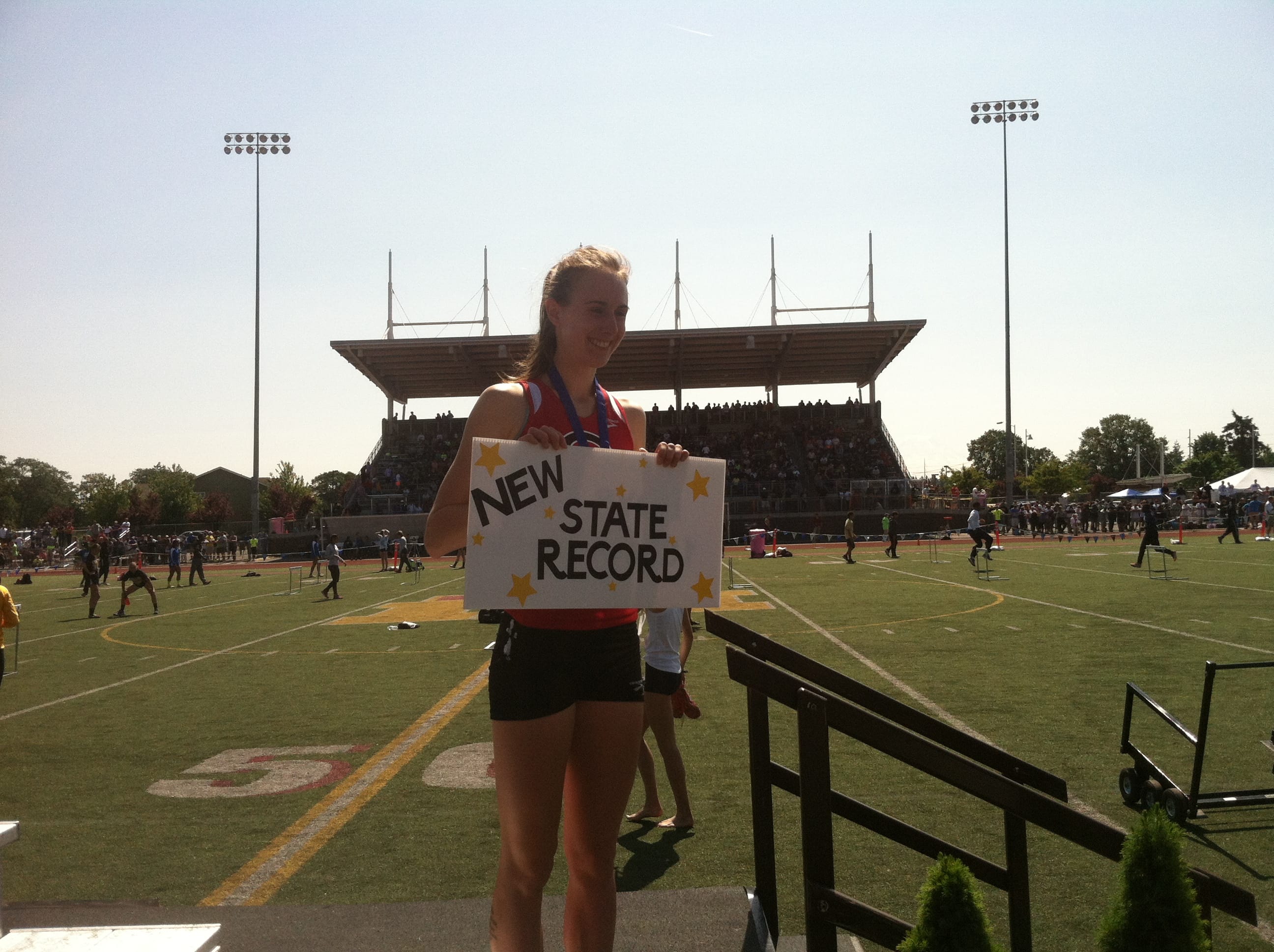 Camas junior Alexa Efraimson is feted on the awards stand after breaking her own state track championships record in the 800 meters on Saturday in Tacoma.
