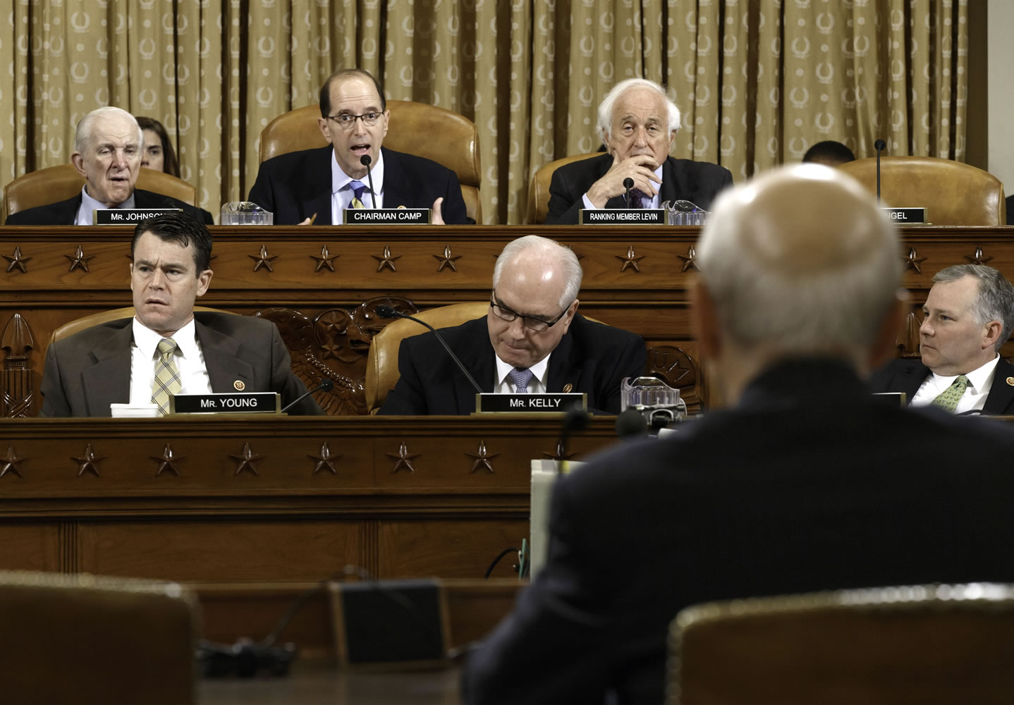 House Ways and Means Committee Chairman Rep. Dave Camp , R-Mich., center, flanked by the committee's ranking member Rep. Sander Levin, D-Mich., right, and Rep.