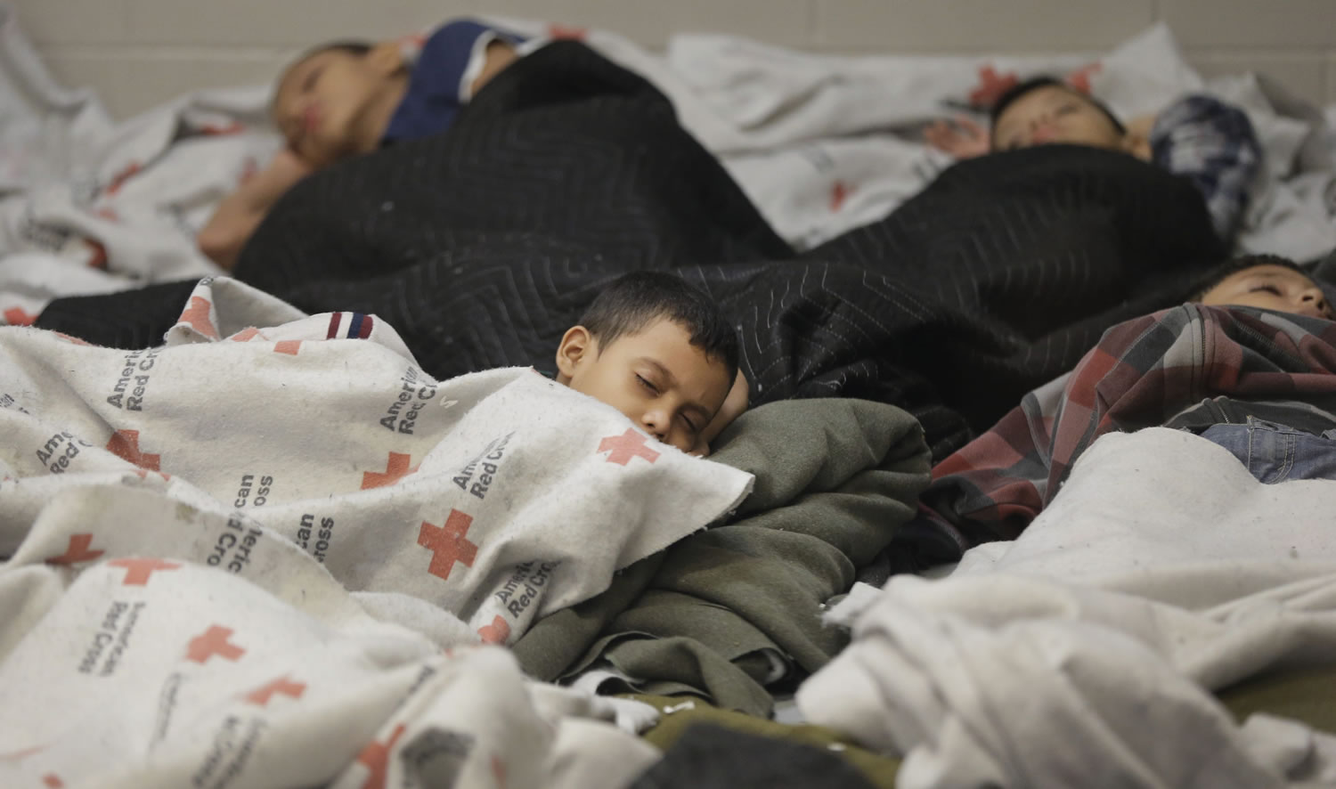 Detained children sleep in a holding cell at a U.S.