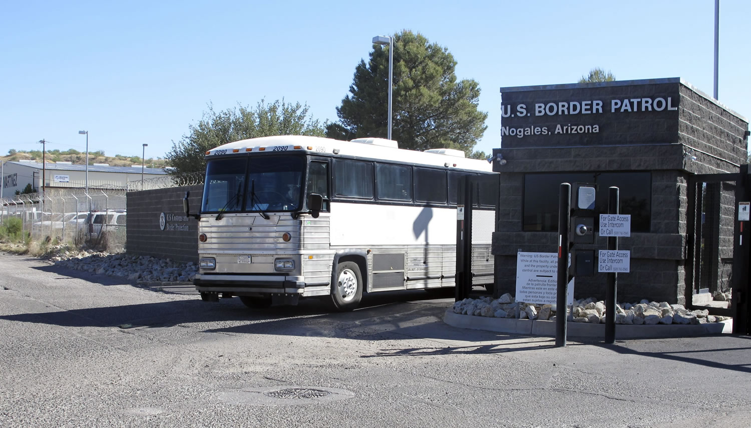 A bus leaves the entrance of the U. S. Border Patrol facility on Saturday in Nogales, Ariz.