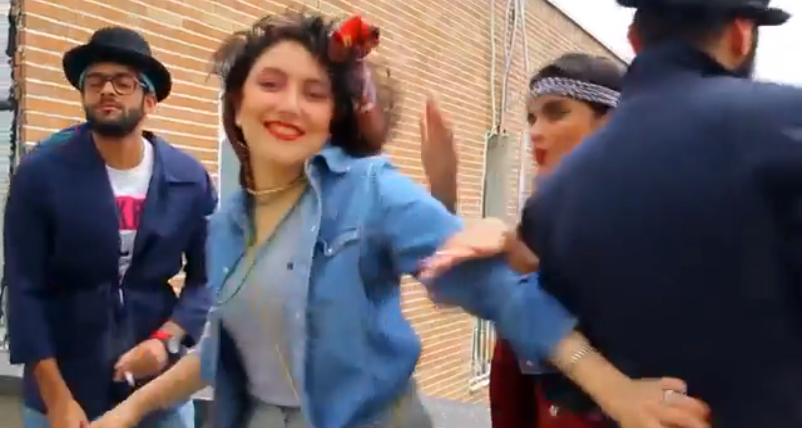 In this frame grab taken from video posted to YouTube, people dance to Pharrell Williams' hit song &quot;Happy&quot; on a rooftop in Tehran, Iran.