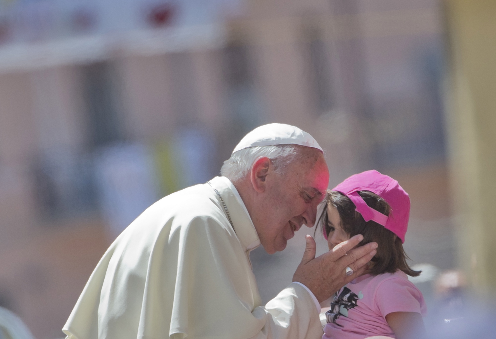 Pope Francis kisses a girl in front the Duomo of Cassano allo Jonio, southern Italy, on Saturday.