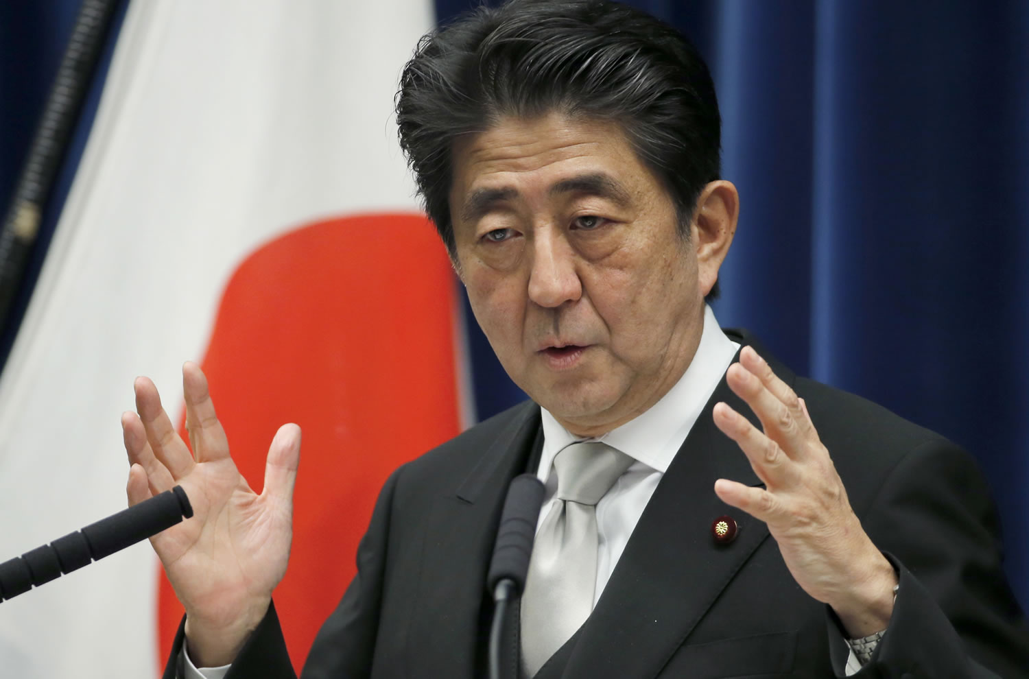 Japan's Prime Minister Shinzo Abe speaks during a press conference at his official residence in Tokyo Wednesday, Dec. 24, 2014. Abe took office Wednesday for a third term as Japan's prime minister, appointing a former military officer as his defense minister but keeping the other members of his previous Cabinet.