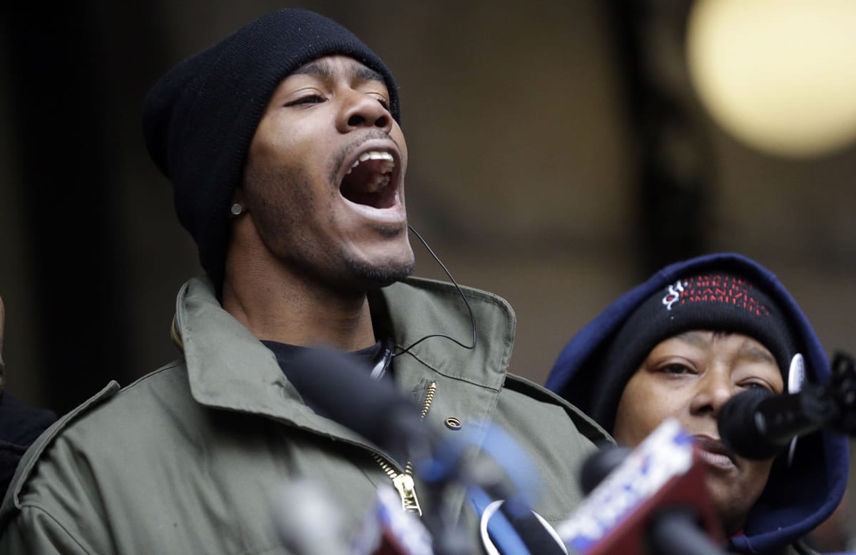 Dontre Hamilton's brother, Nate Hamilton yells on the steps of the federal courthouse Monday, Dec. 22, 2014, in Milwaukee. Milwaukee County District Attorney John Chisholm announced earlier in the day that there would be no charges against former police office Christopher Manney in the fatal shooting of Dontre Hamilton. At right is Maria Hamilton, mother of Dontre Hamilton.