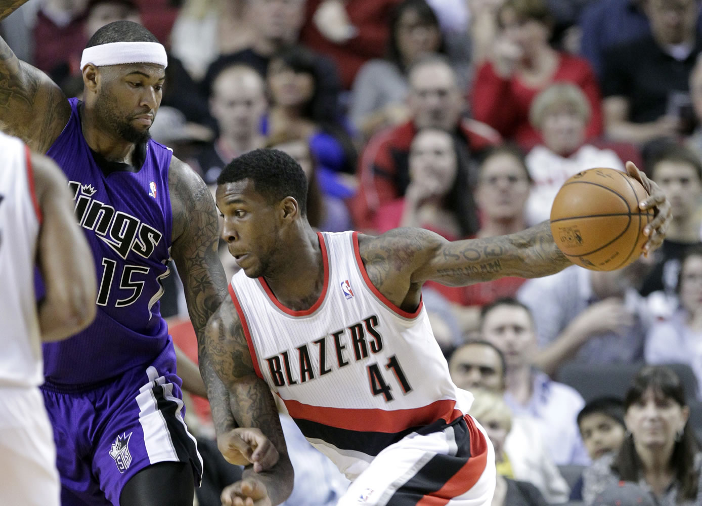 Portland Trail Blazers forward Thomas Robinson, right, drives against Sacramento center DeMarcus Cousins during the first half Wednesday in Portland.