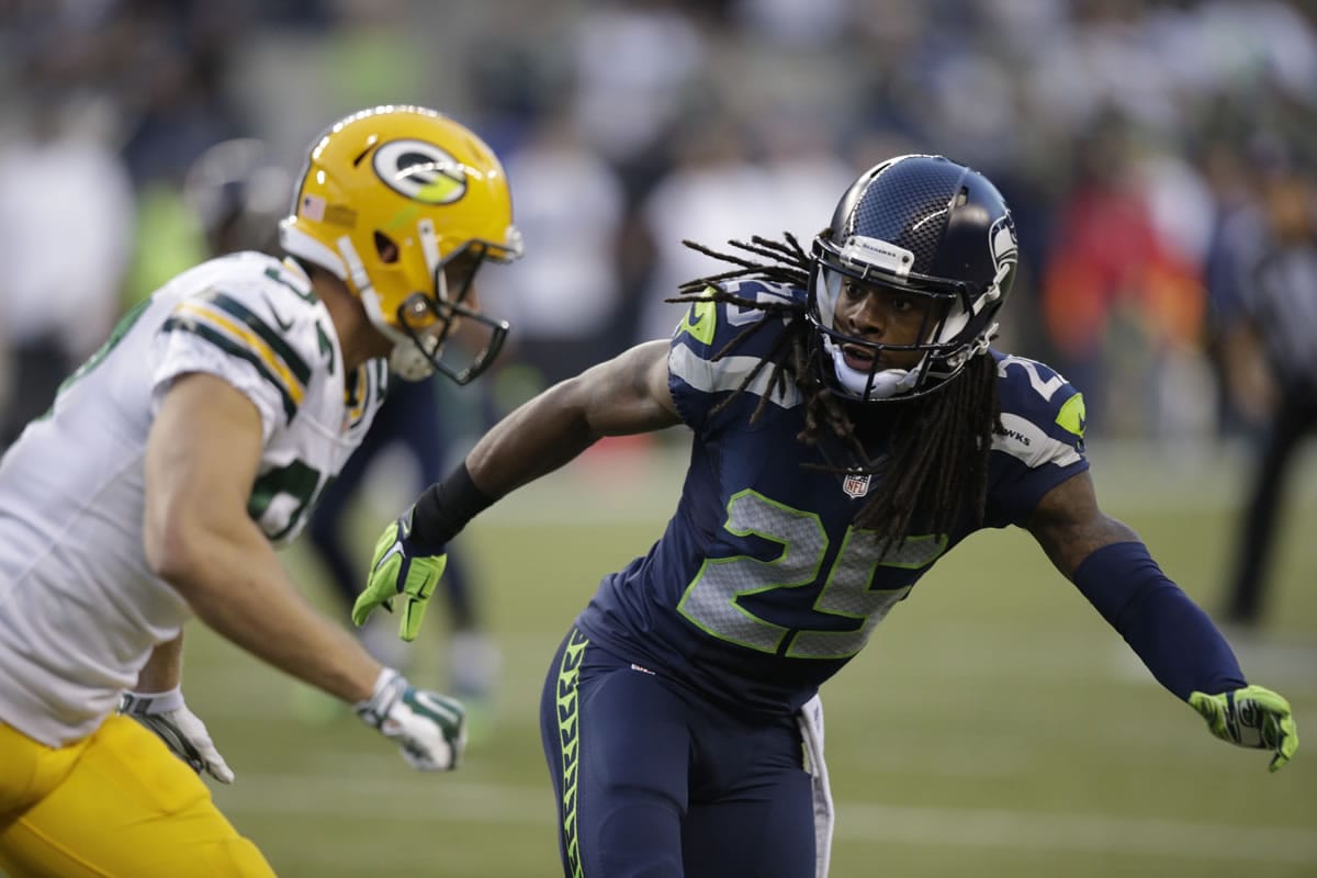 Seattle Seahawks cornerback Richard Sherman (25) begins pass coverage against a Green Bay Packers receiver during a game last season in Seattle.