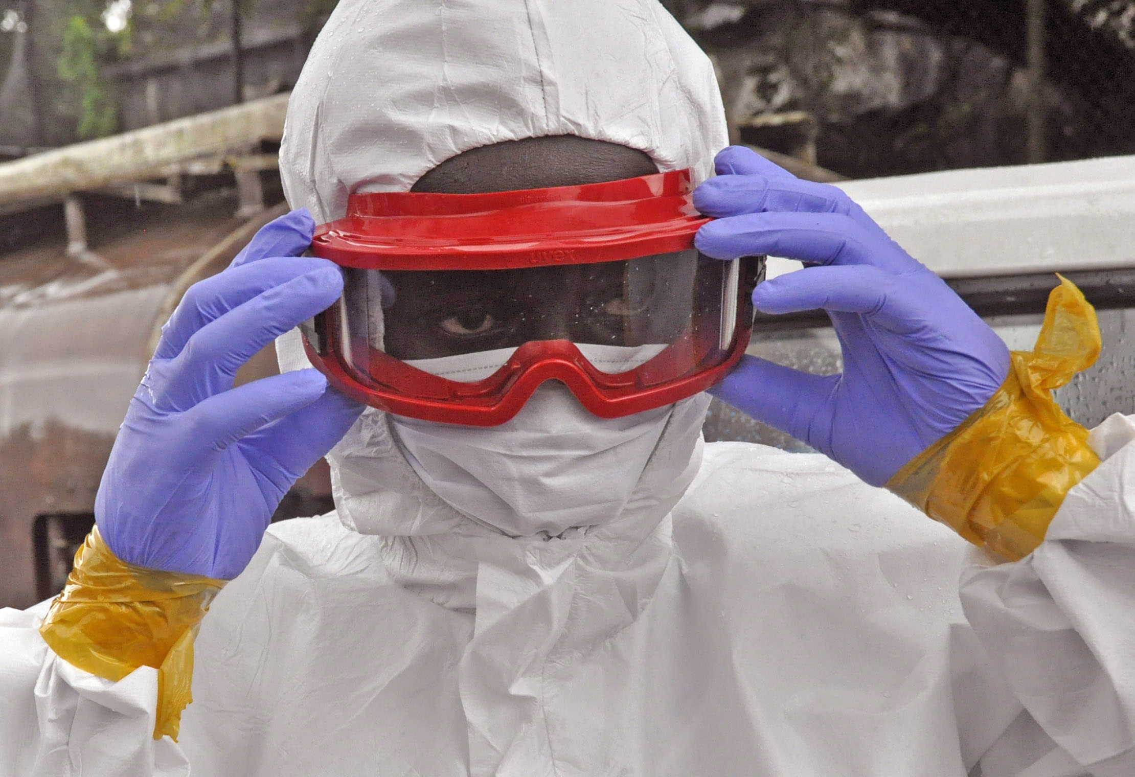 A health worker prepares his protective gear before moving the body of a man believed to have died from the Ebola virus Friday in Monrovia, Liberia.