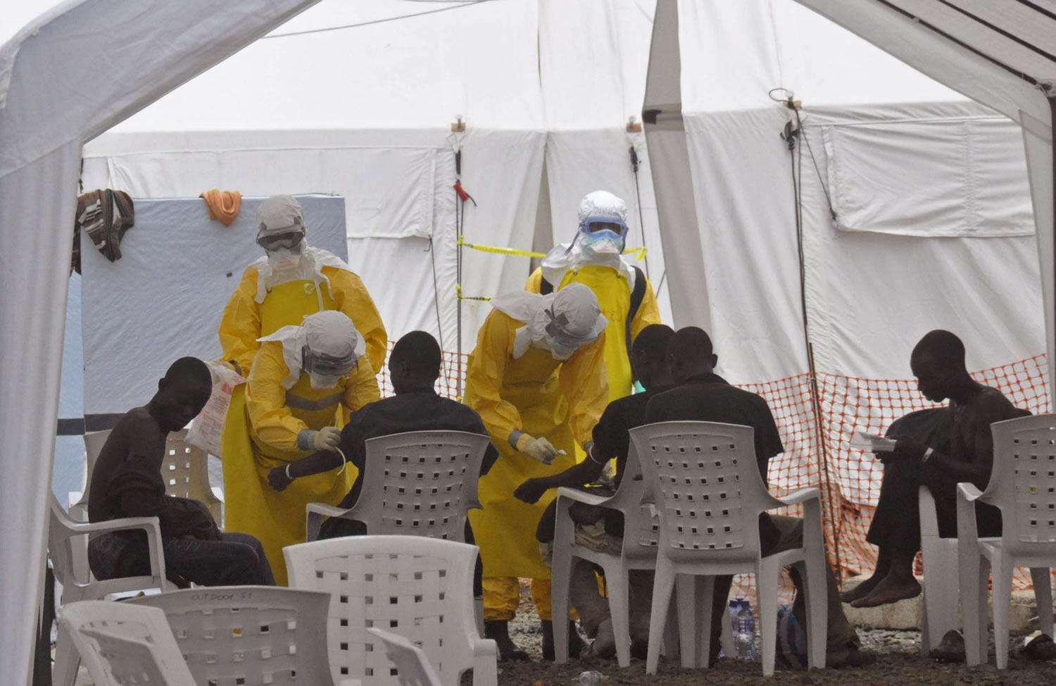 Health workers on Monday in Monrovia, Liberia, attend to patients who contracted the Ebola virus.