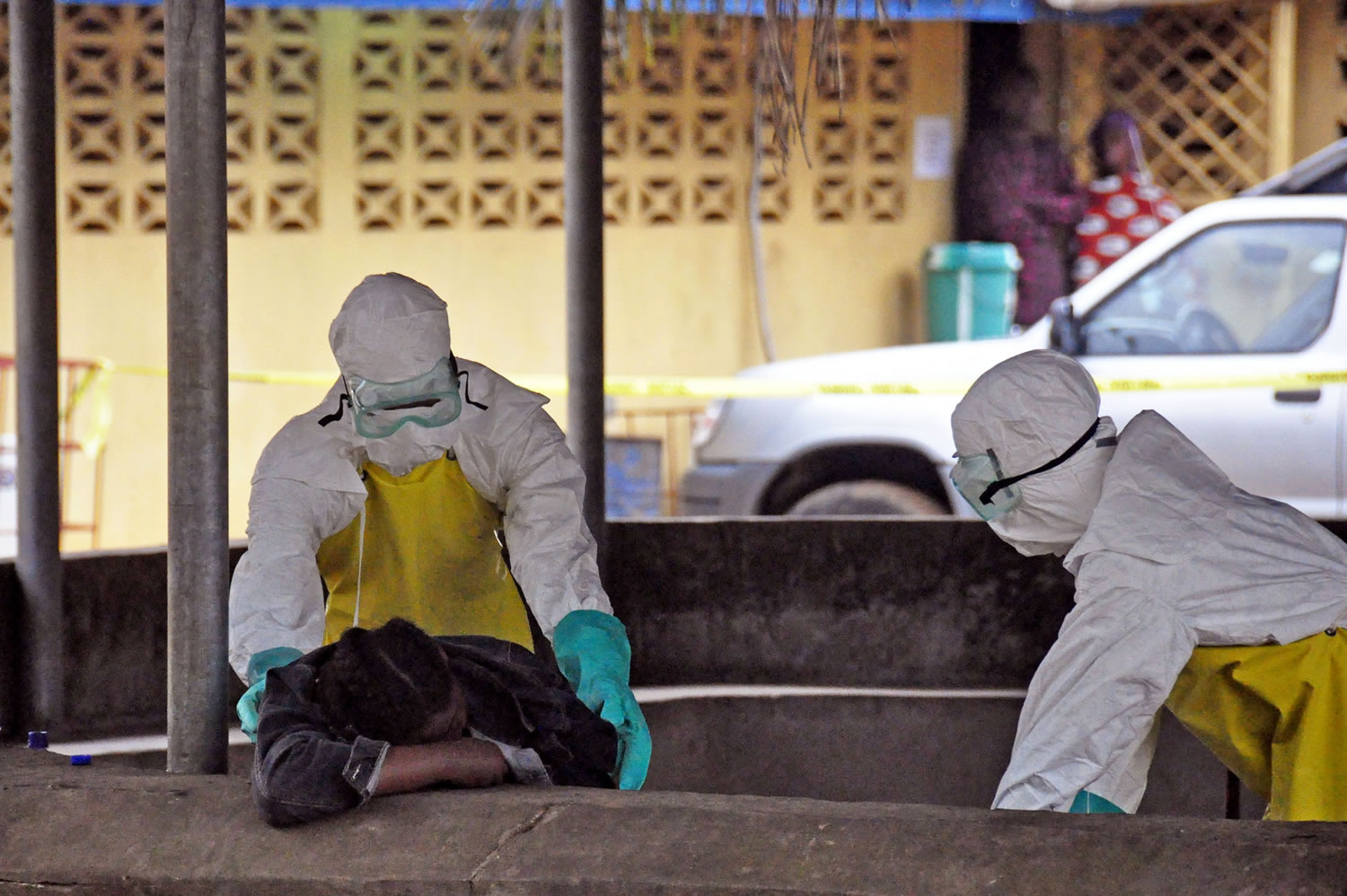 Health workers move the body of a fellow health worker who was found dead in a seat, and who they believe passed away from the Ebola virus, at one of the largest hospitals in the city of Monrovia, Liberia, on Saturday.