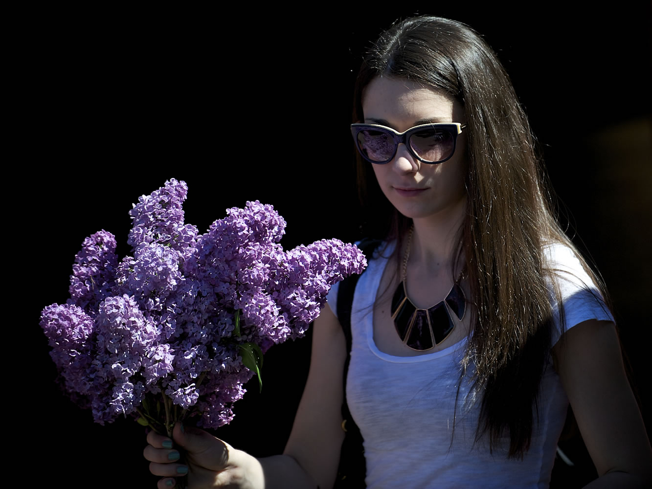 Anastasia Colesnic, 21, of Vancouver, holds a lilac bouquet that she planned to share with a friend during Lilac Days in Woodland.