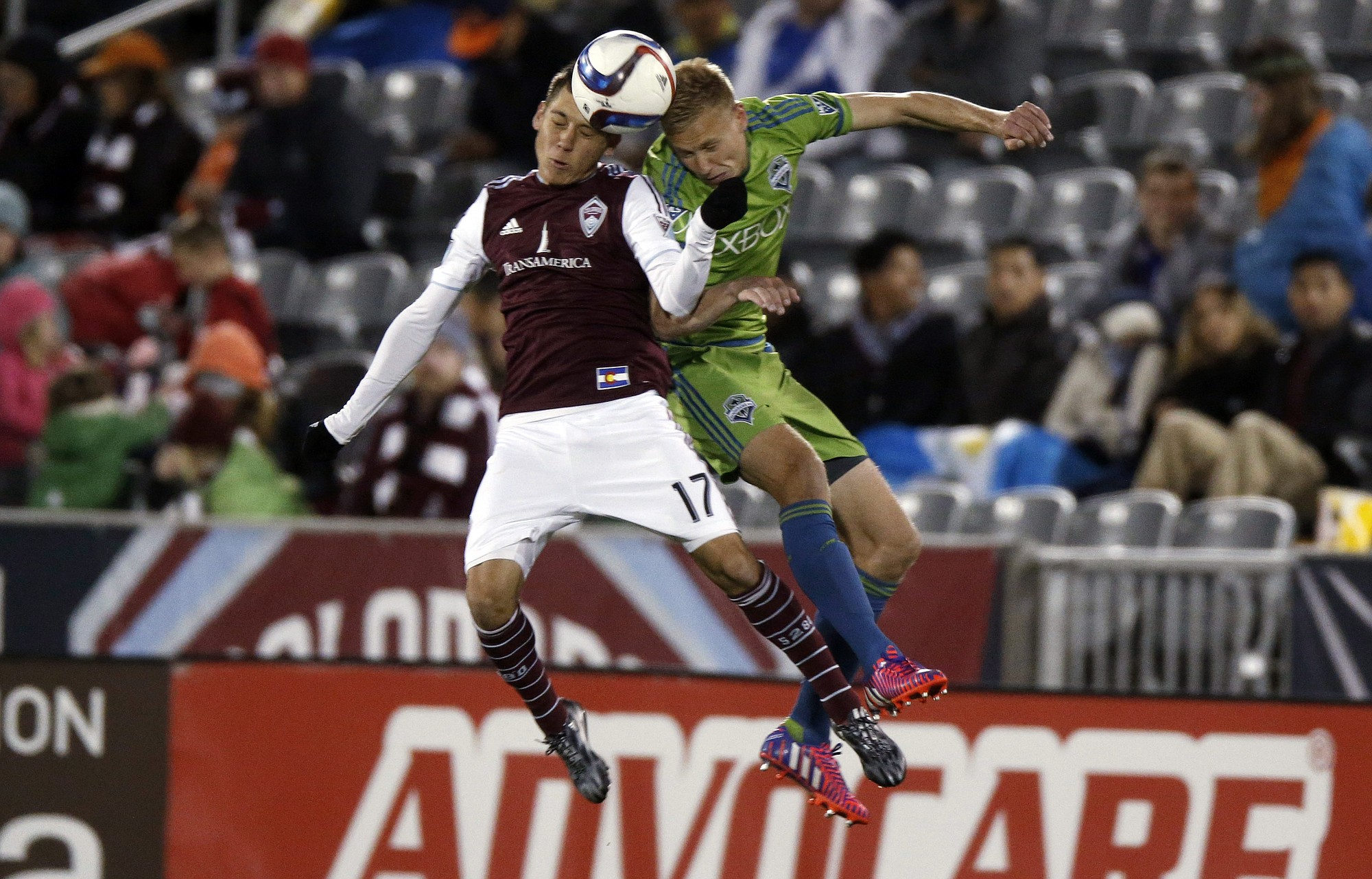 Colorado Rapids midfielder Dillon Serna, left, tries to head the ball with Seattle Sounders midfielder Andy Rose in the second half Saturday, April 18, 2015, in Commerce City, Colo. Seattle won 3-1.