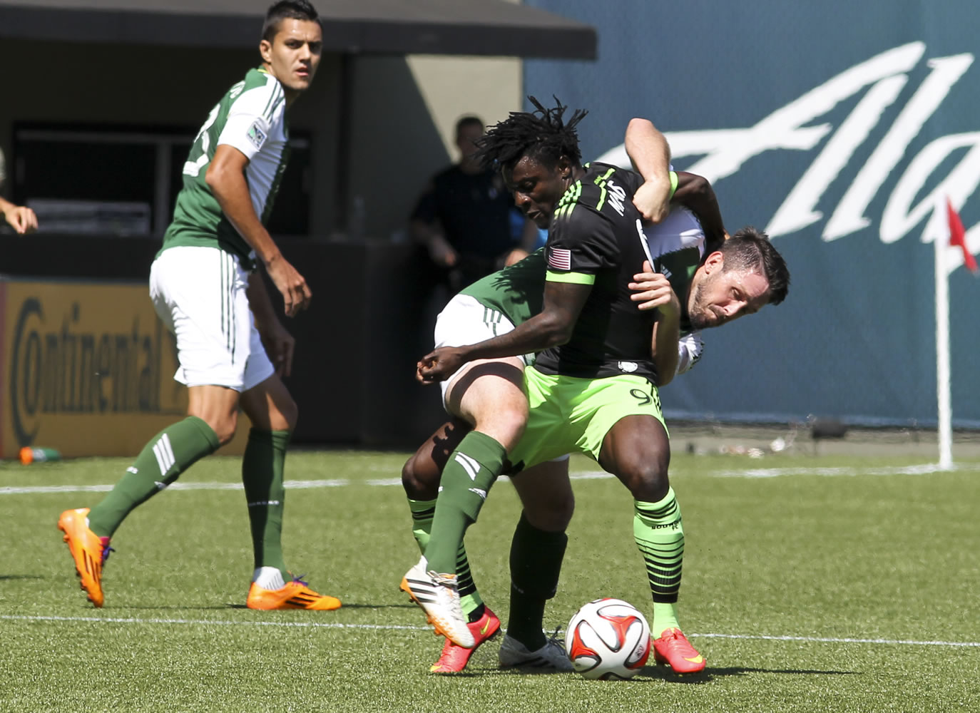 Seattle Sounders player Obafemi Martins, front, vies for the ball against Portland Timbers' Danny O'Rourke Sunday in Portland.