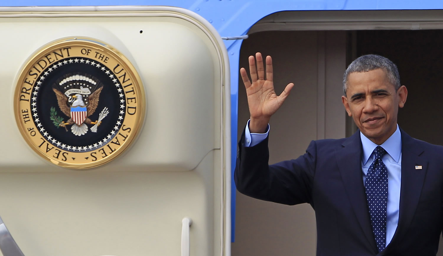 President Barack Obama waves from Air Force One during his tour of nations in Asia.