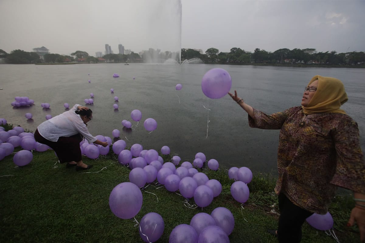 Women release balloons to symbolize their prayers for the 239 passengers on board the missing Malaysia Airlines flight MH370 at a park at Kuala Lumpur, Malaysia, on Sunday.