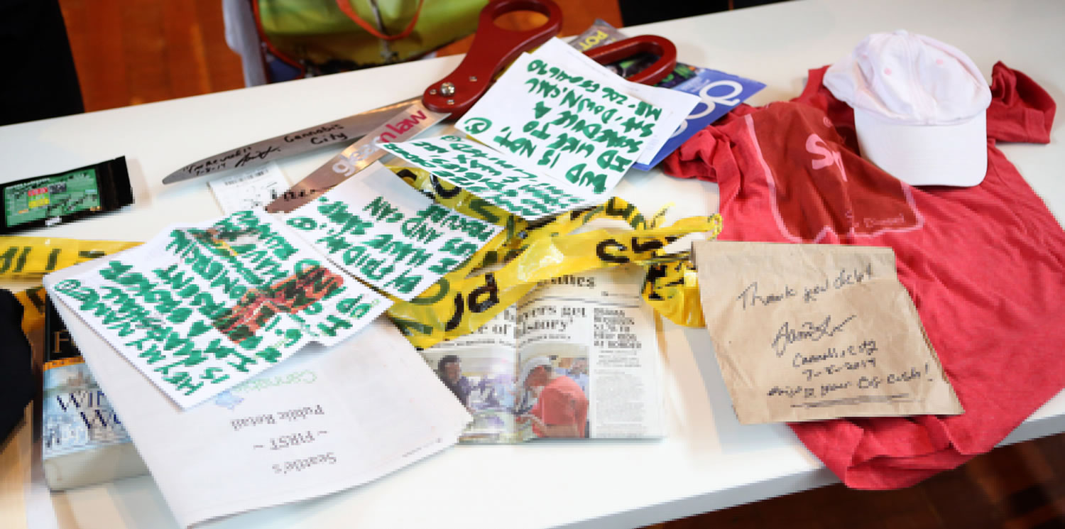 Items Deb Greene, a 65-year-old Ballard grandmother, donated to the Museum of History and Industry in Seattle on July 22 include two grams of the Sweet Lafayette strain of cannabis, upper left, part of Seattle's first legal pot purchase, along with clothes she wore and the book she read as she waited for 21 hours at the front of the line, all of which will go into MOHAI's permanent collection.