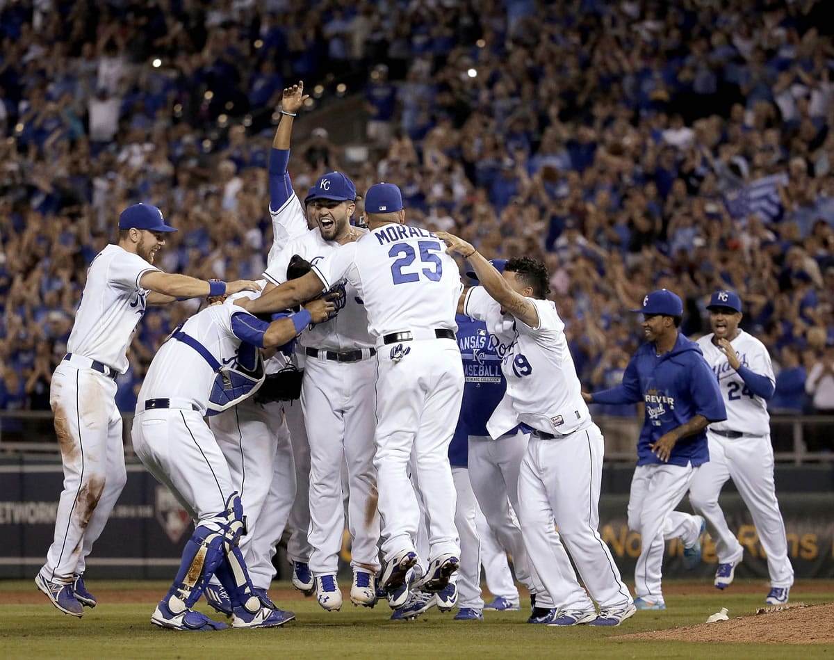 Kansas City Royals celebrate their division title after defeating the Seattle Mariners on Thursday, Sept. 24, 2015, in Kansas City, Mo.