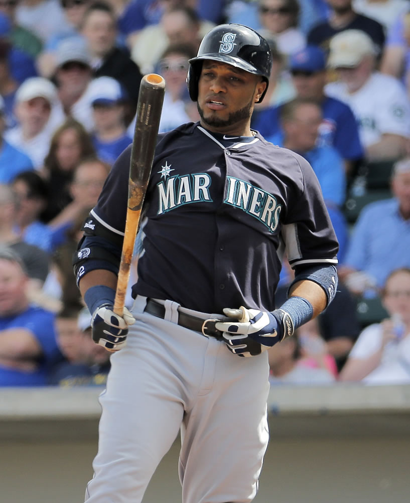 Seattle Mariners' Robinson Cano looks at his bat during the first inning of a spring training baseball game against the Chicago Cubs Thursday, March 20, 2014, in Mesa, Ariz.