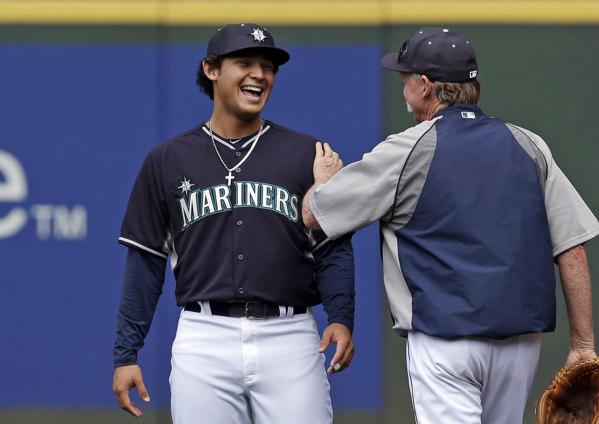 Seattle Mariners' Alex Jackson, left, a newly signed draft pick, talks with pitching coach Rick Waits after taking part in batting practice with the team Monday.
