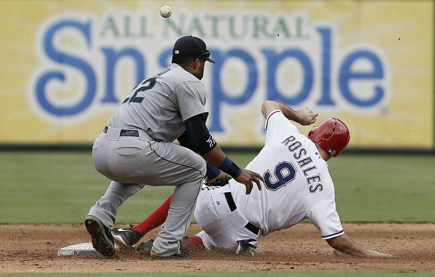 Seattle Mariners second baseman Robinson Cano (22) is unable to hold onto the throw from home as Texas Rangers' Adam Rosales (9) steals second during the sixth inning of a baseball game, Sunday, Sept. 7, 2014, in Arlington, Texas. Rosales would take third on the play.