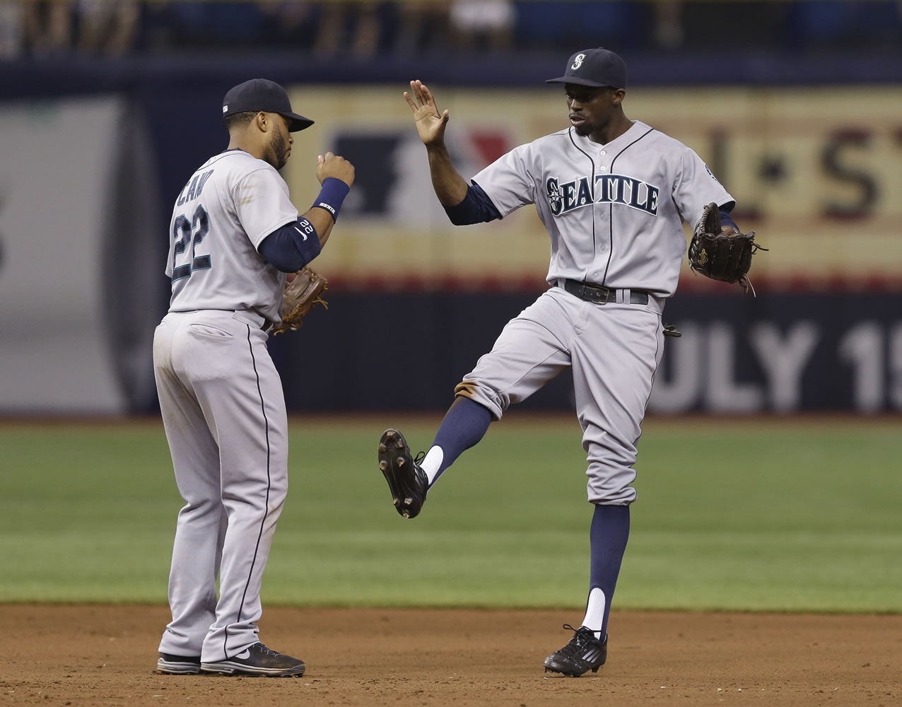 Seattle Mariners center fielder James Jones, right, celebrates with second baseman Robinson Cano after the team defeated the Tampa Bay Rays 7-4 Saturday in St.