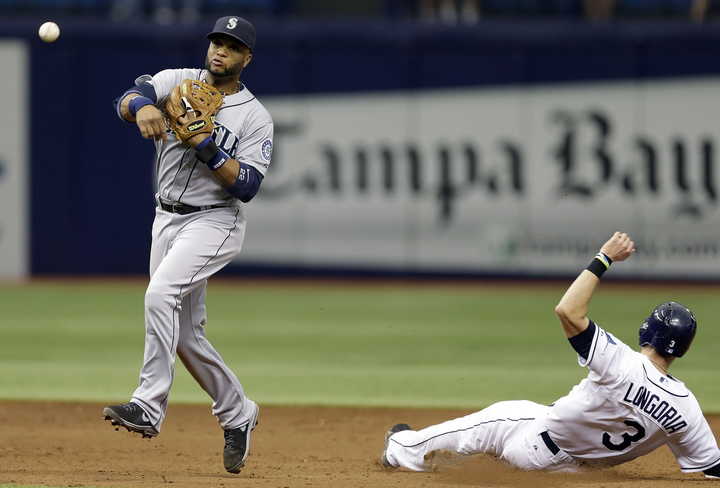 Seattle Mariners second baseman Robinson Cano, left, forces Tampa Bay Rays' Evan Longoria at second base and turns an unassisted double play on James Loney during the seventh inning of a baseball game Monday, June 9, 2014, in St. Petersburg, Fla.