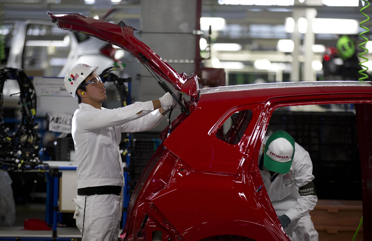 Employees work Friday in the new Honda car plant in Celaya, in the central Mexican state of Guanajuato.