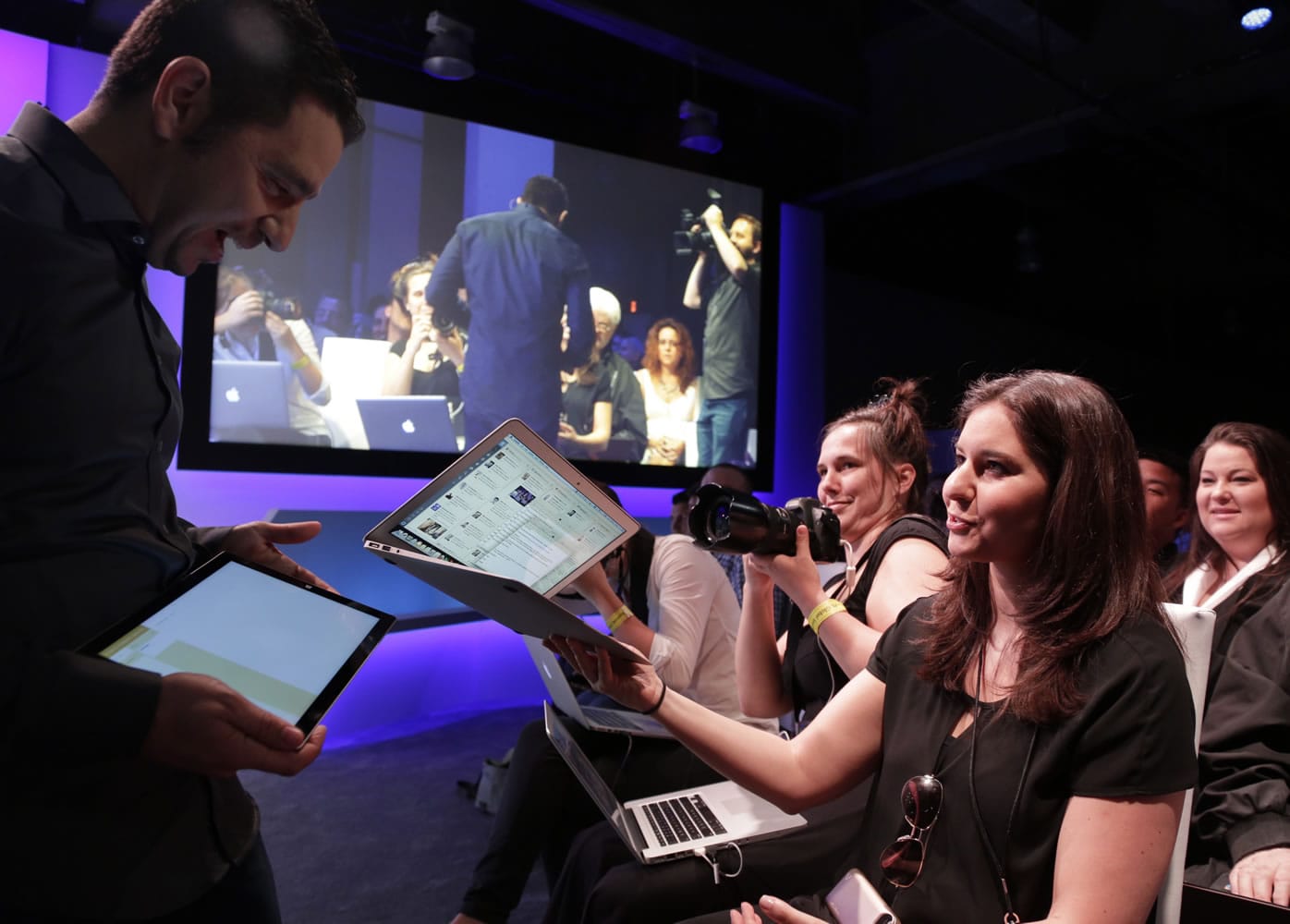 Panos Panay, left, hands a Surface Pro 3 to Joanna Stern, the personal technology columnist for The Wall Street Journal.