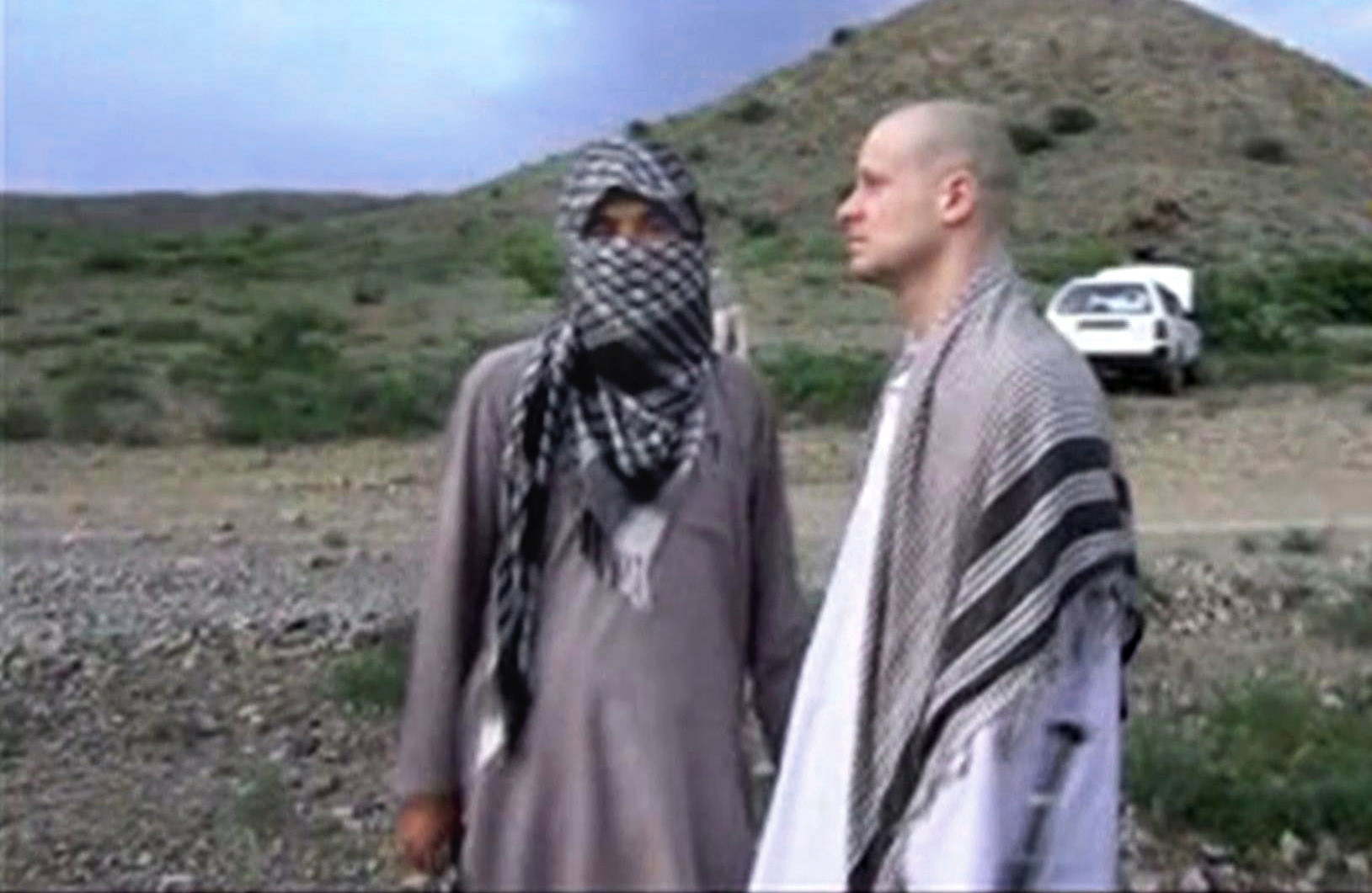 FILE - In this file image taken from video obtained from Voice Of Jihad Website, which has been authenticated based on its contents and other AP reporting, Sgt. Bowe Bergdahl, right, stands with a Taliban fighter in eastern Afghanistan. Bergdahl was freed in a swap in which the U.S. freed five Taliban detainees, a diplomatic victory for the insurgent group. In a belt from Iraq to Pakistan, militants scored a series of successes the past weeks, a sign of their continued power 13 years into the U.S.