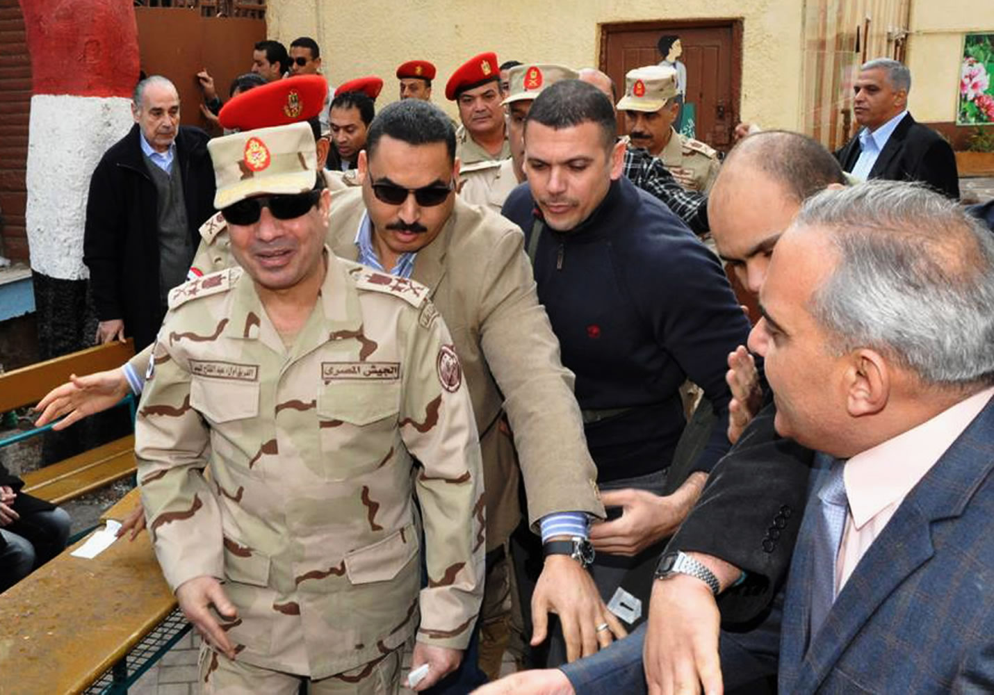 Defense Minister Gen. Abdel-Fattah el-Sissi, left, visits a polling site in the Heliopolis neighborhood of Cairo, Egypt, on the first day of voting in the constitutional referendum Jan.
