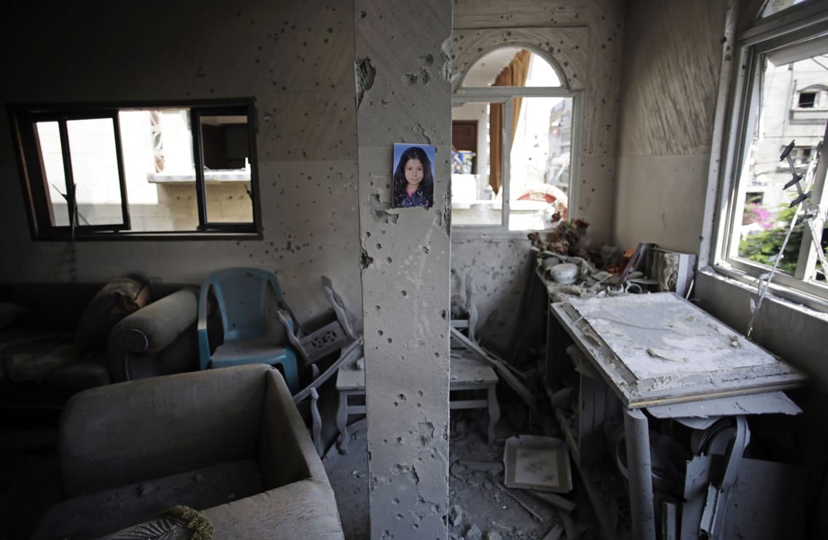 A portrait of Shahed Quishta, 8, is displayed on a concrete pillar damaged by an Israeli tank shell that slammed into the family living room on July 22, killing Shahed, in Beit Lahiya, Gaza Strip.