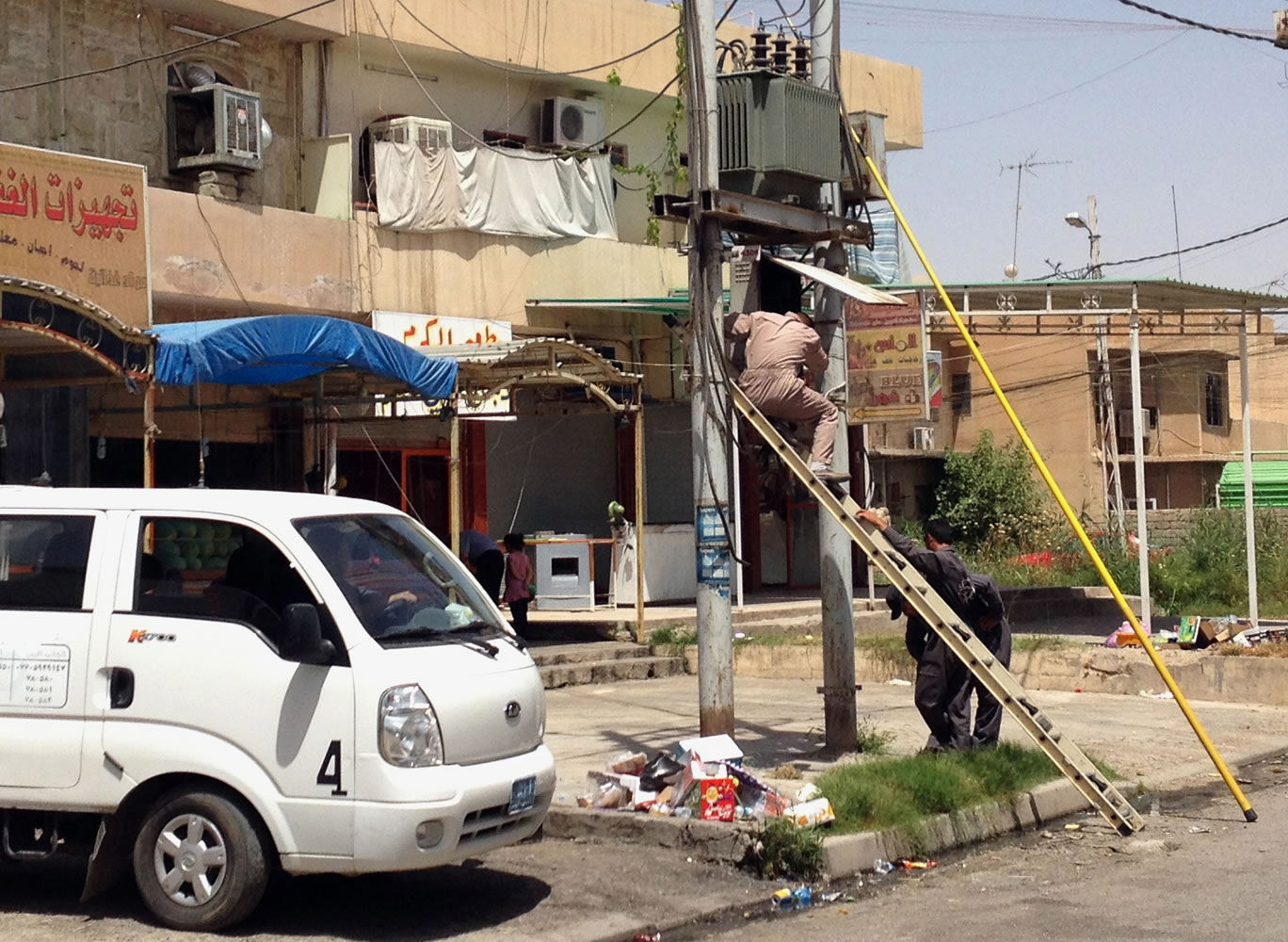 Iraqi electricity company workers repair a transformer in the northern city of Mosul, Iraq, ten days after the Islamic State of Iraq and the Levant took over the countryu2019s second largest city.