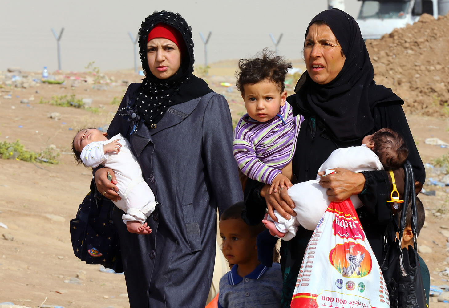 Associated Press
Iraq refugees fleeing from Mosul head to the self-ruled northern Kurdish region Thursday in Irbil, Iraq, 217 miles north of Baghdad. An estimated half a million residents fled Mosul, an economically important city.