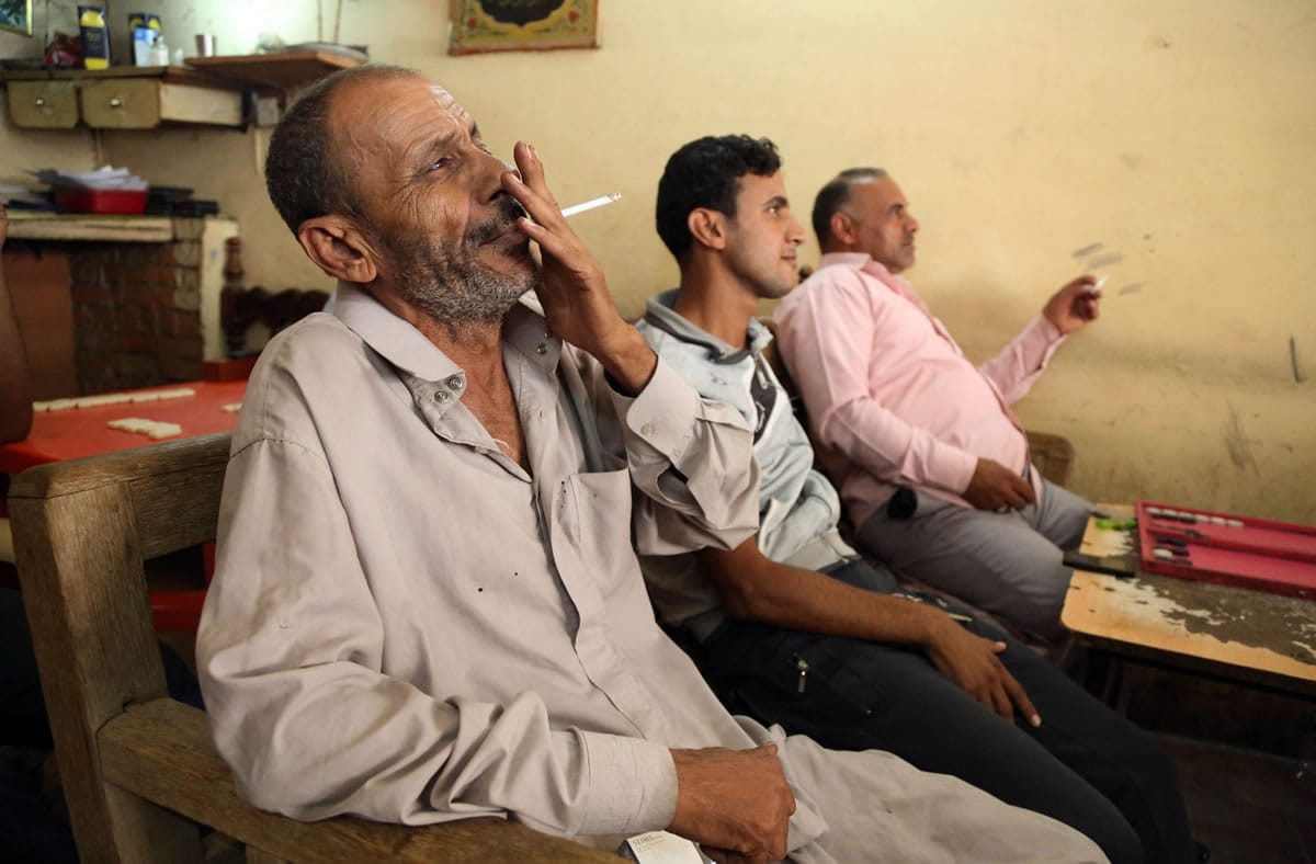 People watch an address by Iraqu2019s Prime Minister Nouri al-Maliki on television at a cafe in Baghdadu2019s Karrada neighborhood on Wednesday.